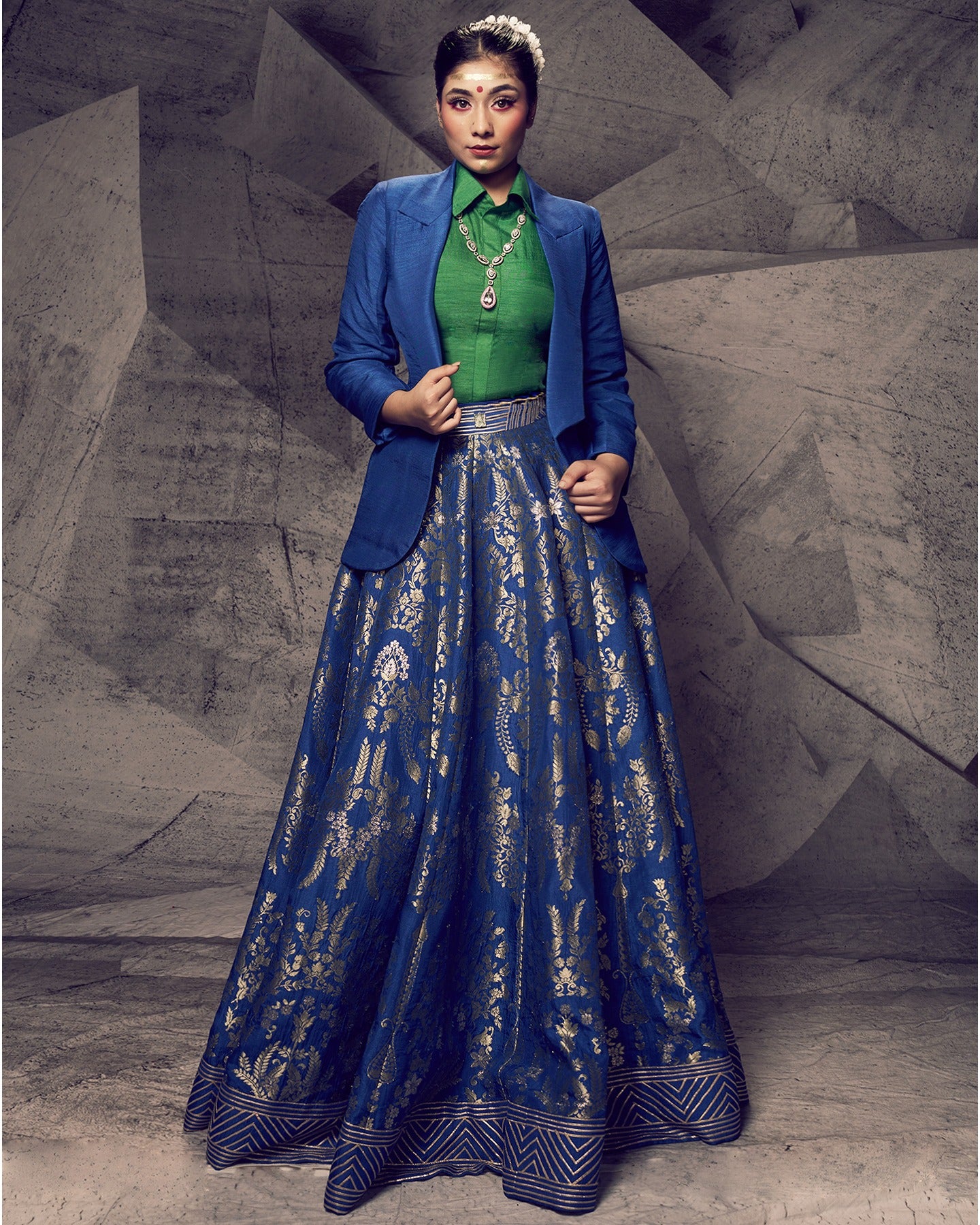 Drenched in the hues of nature, this blue and green lehenga with a collared shirt and blazer is a modern masterpiece.