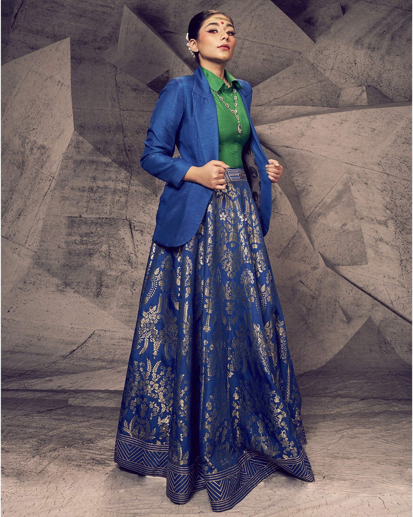 Drenched in the hues of nature, this blue and green lehenga with a collared shirt and blazer is a modern masterpiece.