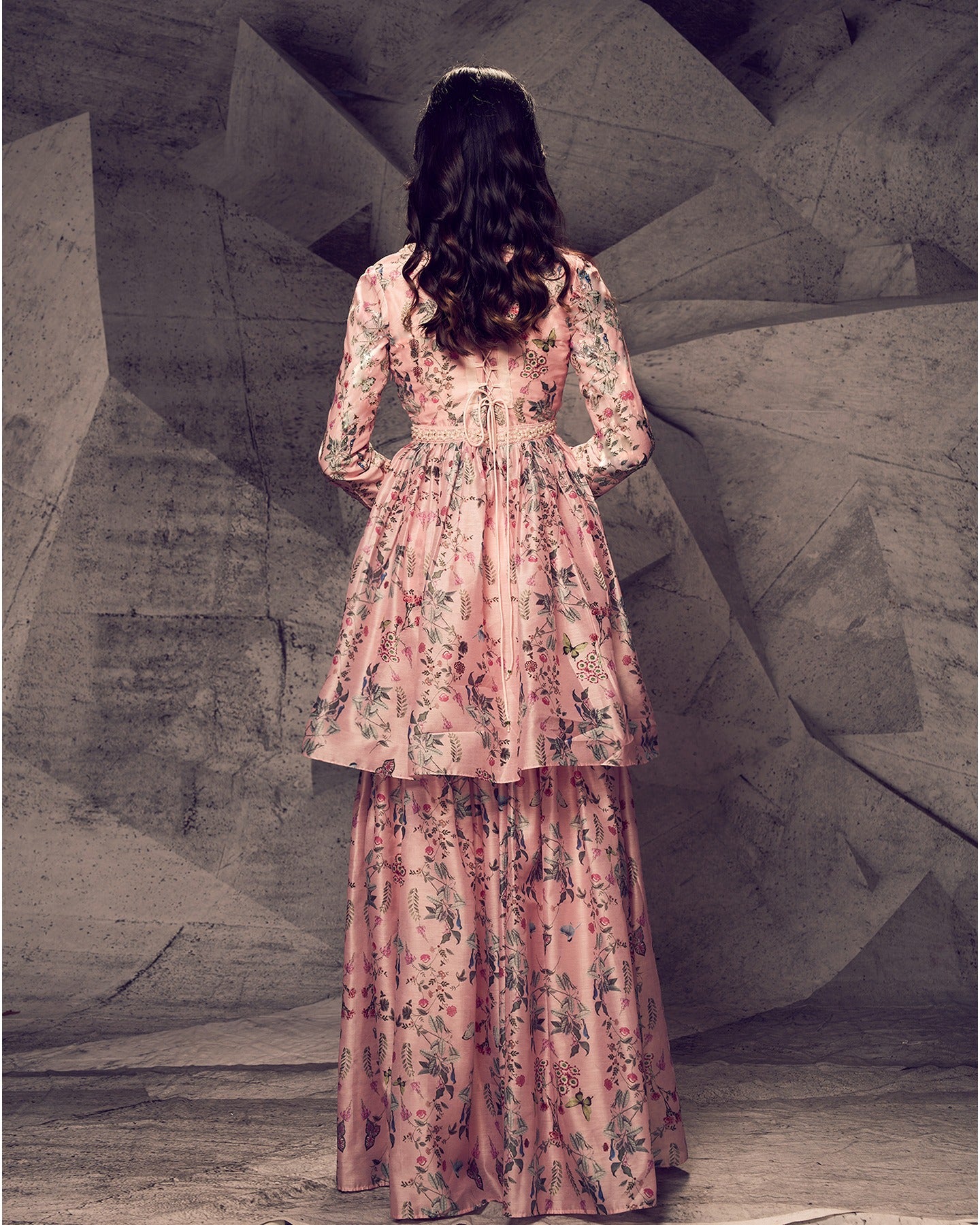 Bathed in the enchanting hues of pink, this sharara ensemble is adorned with delicate pearl embroidery, creating a look that is both graceful and timeless.