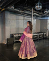Traditional purple bridal lehenga with a modern twist, adorned with sequins and floral patterns.