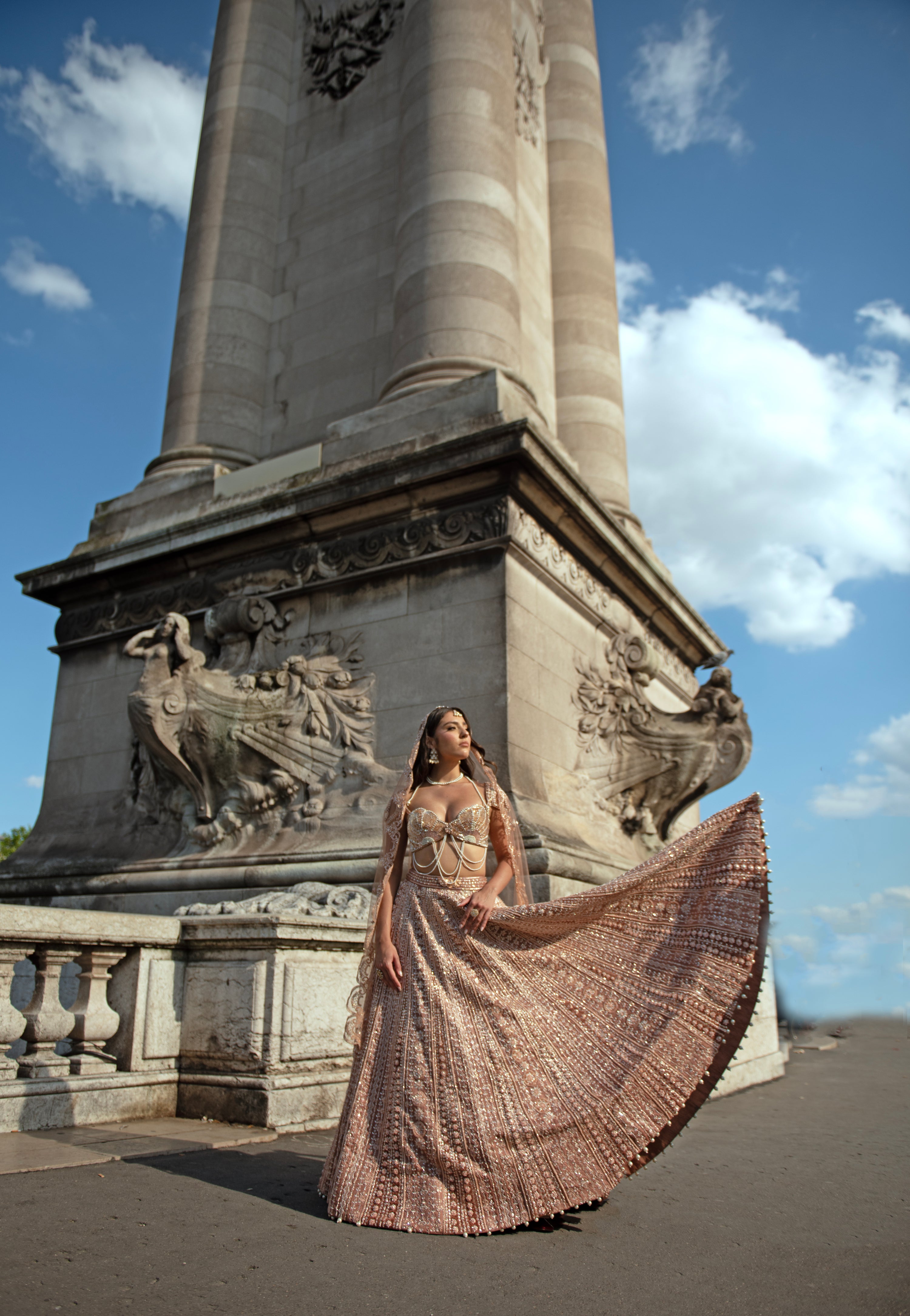 Caramel brown lehenga set with intricate hand embroidery, pearl details, and elegant pearl danglers. The linen silk lehenga is paired with a net and linen silk blouse inspired by a sea shell silhouette, complemented by a delicate net dupatta