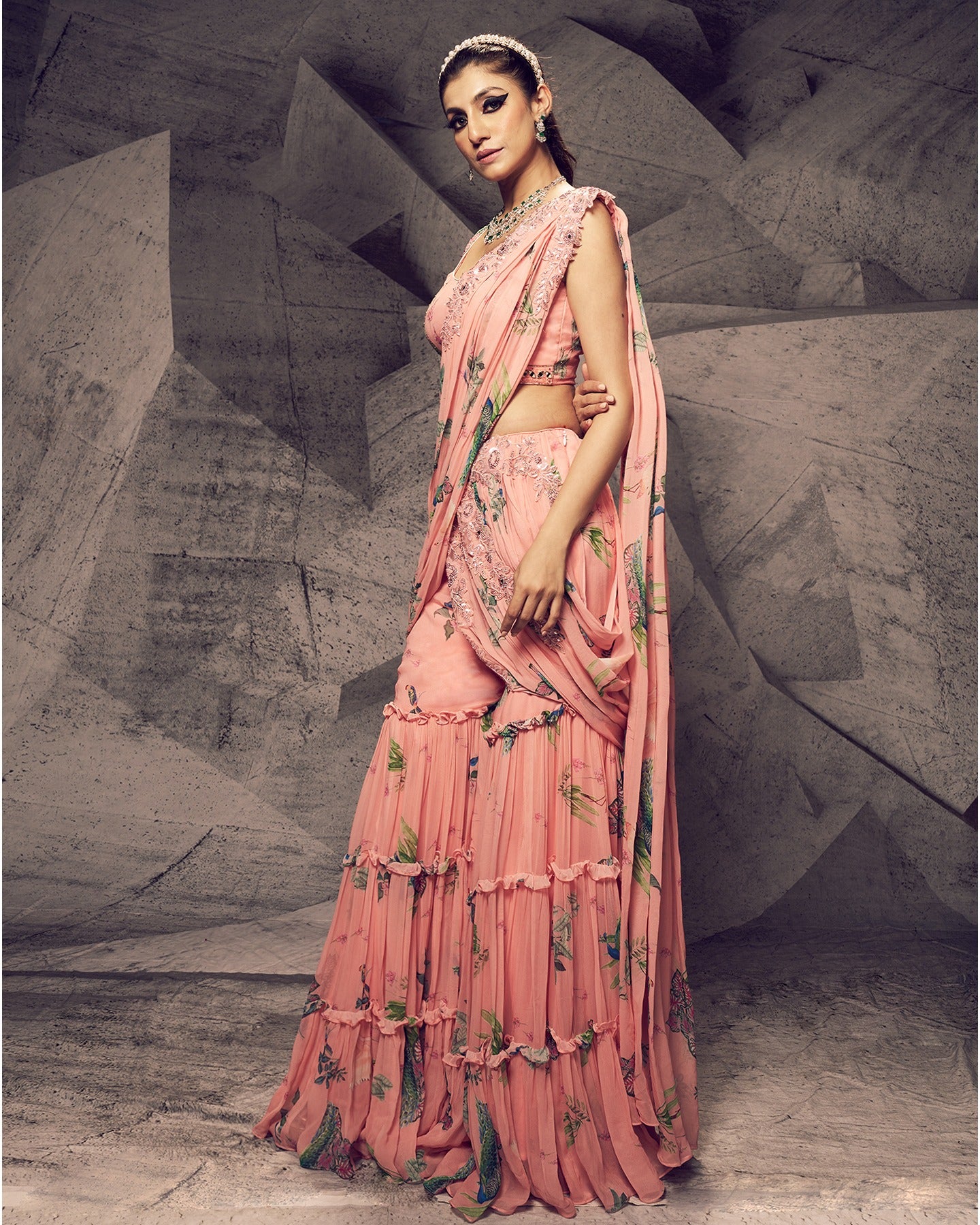 Bathed in the enchanting hues of pink, this sharara ensemble is adorned with delicate pearl embroidery, creating a look that is both graceful and timeless.
