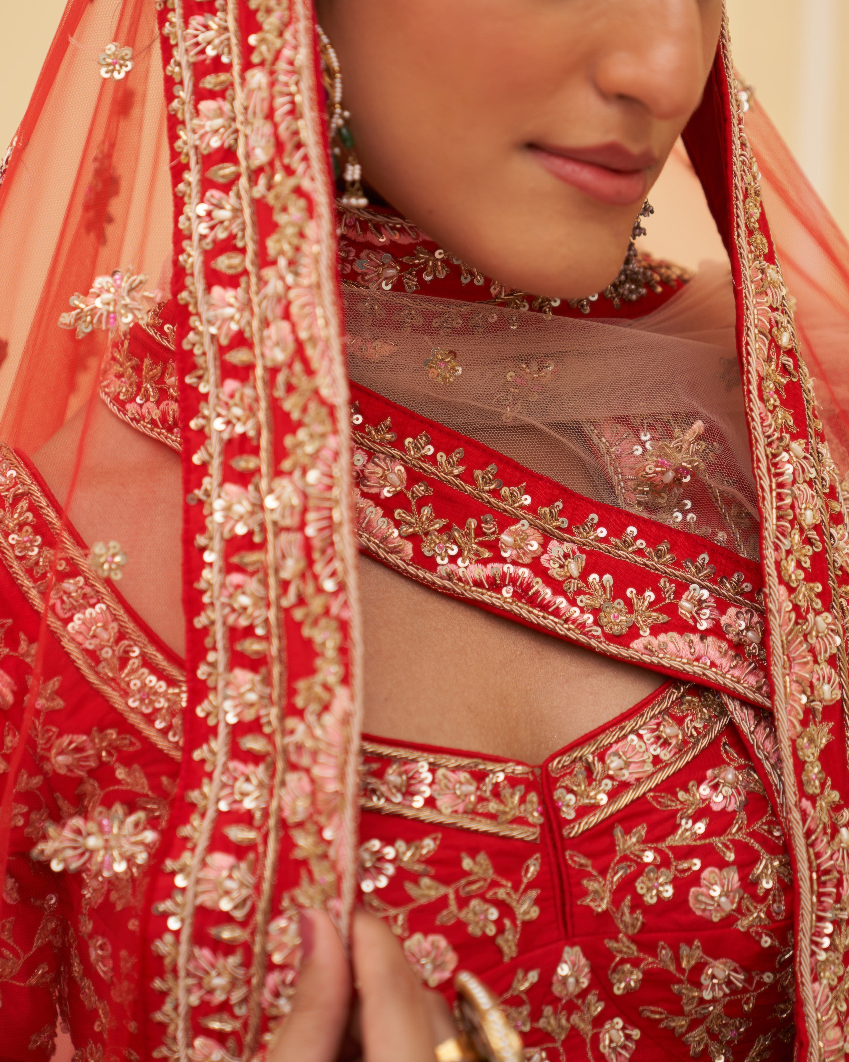 Exquisite red silk bridal lehenga adorned with traditional motifs