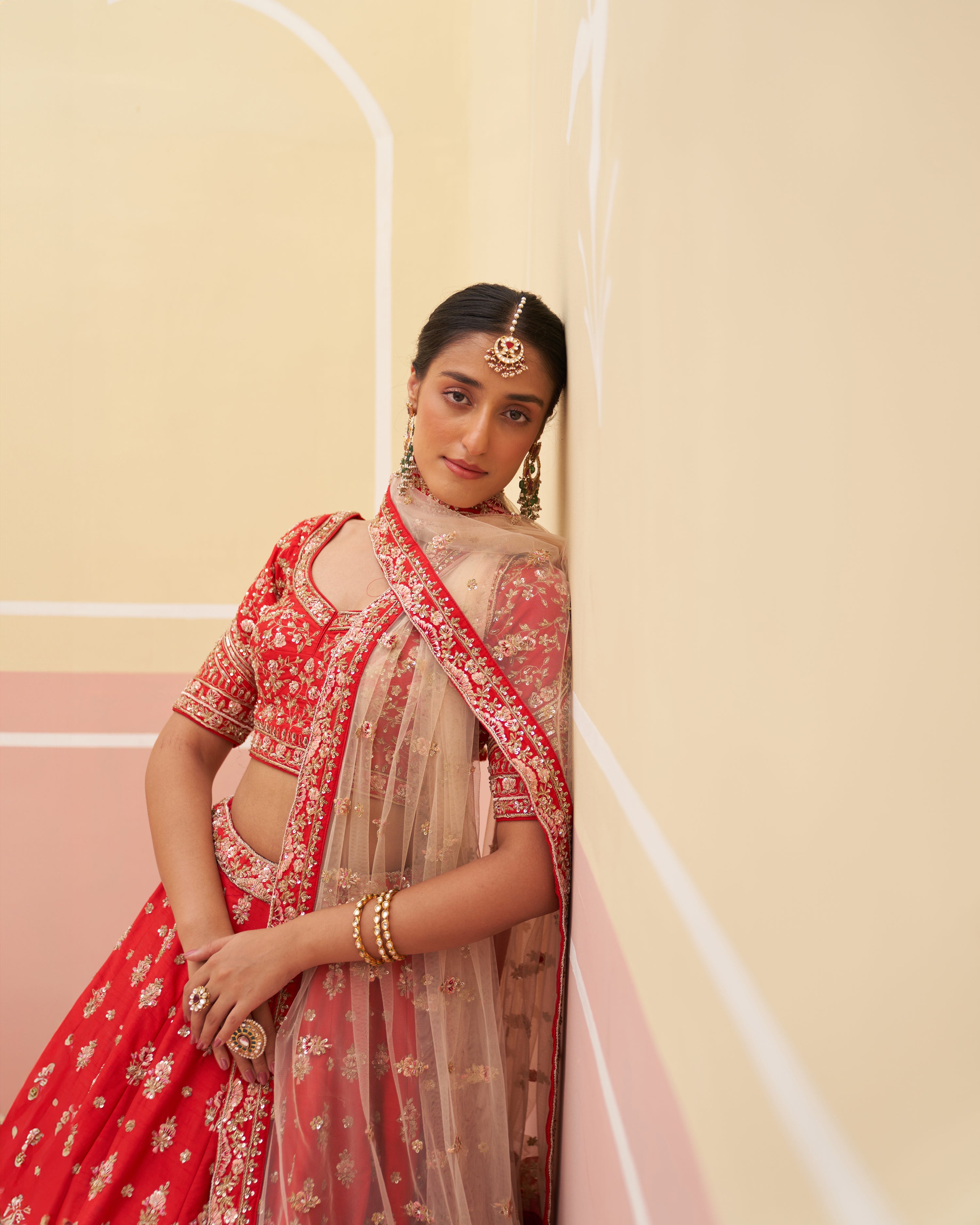 Rich red raw silk bridal lehenga with intricate detailing