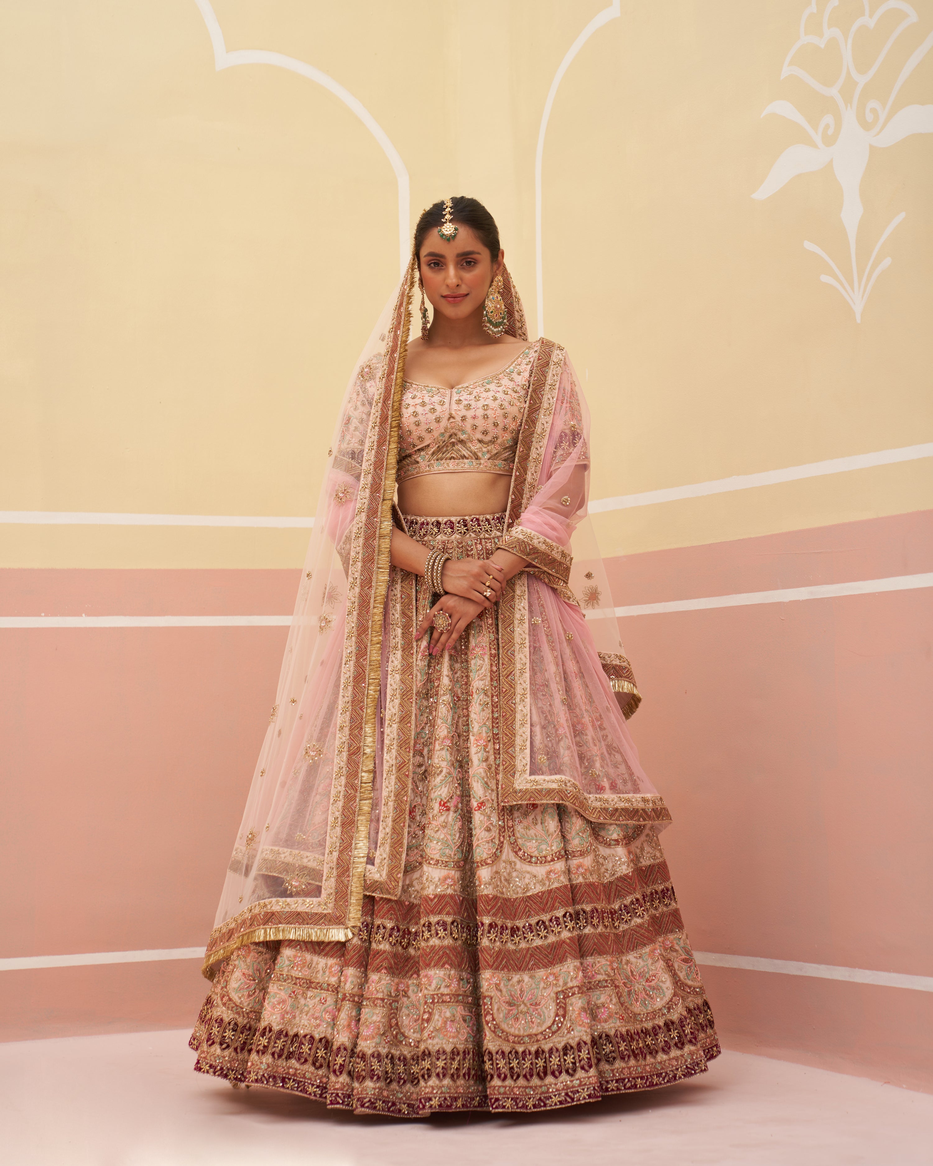 Elegant peach raw silk lehenga set with intricate gold embroidery