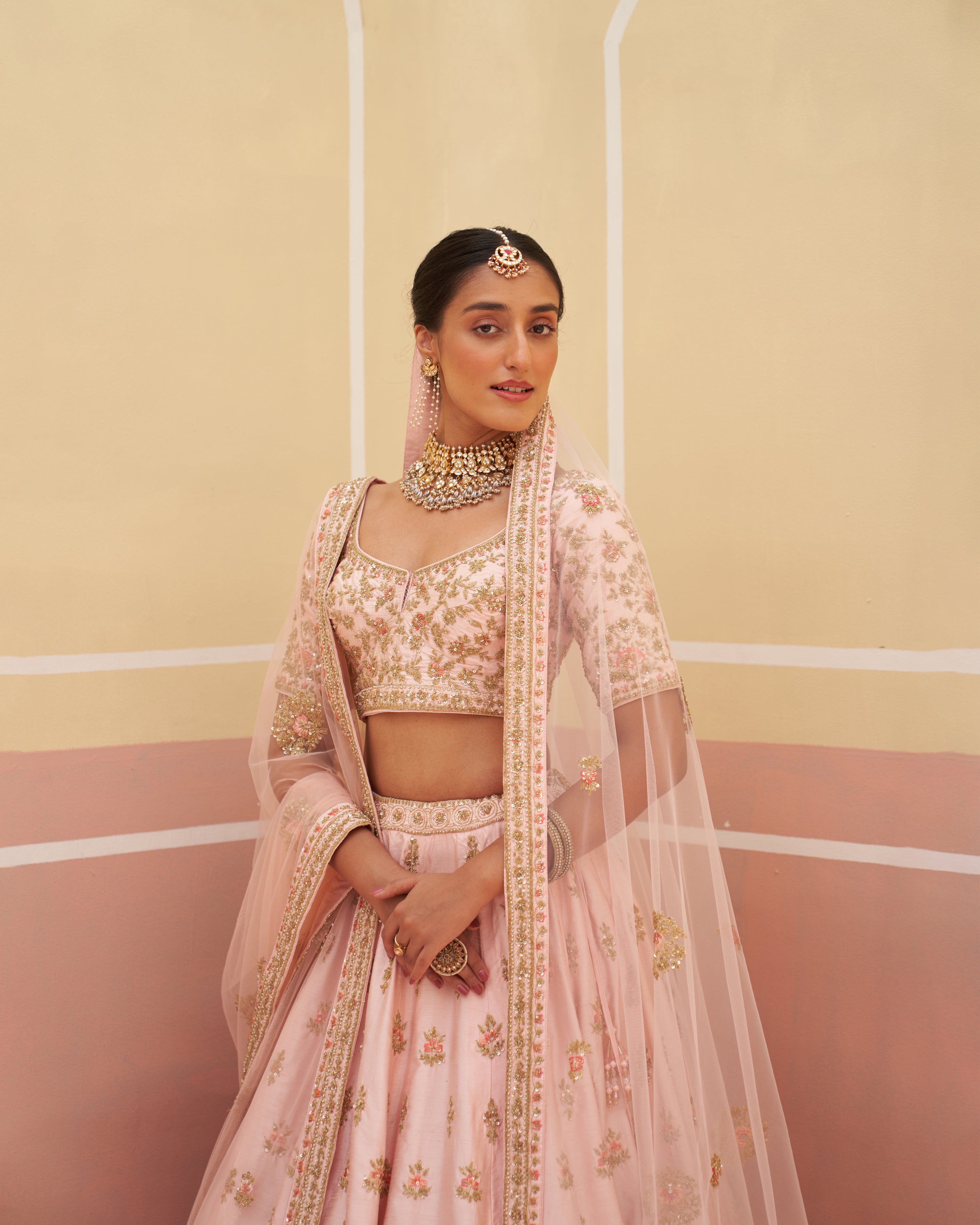 Charming pink raw silk lehenga set adorned with gold embellishments