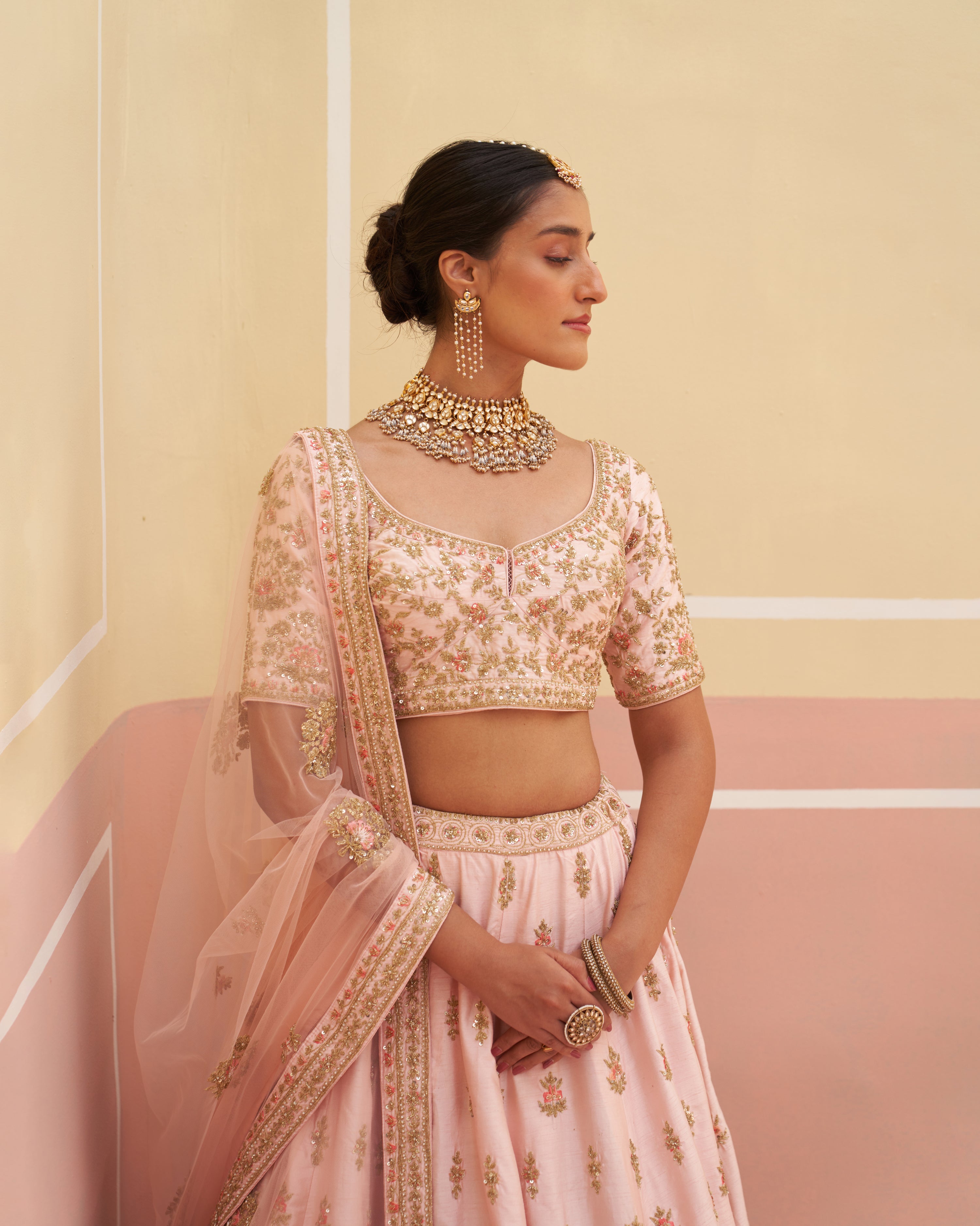 Regal pink raw silk lehenga set for a timeless bridal ensemble