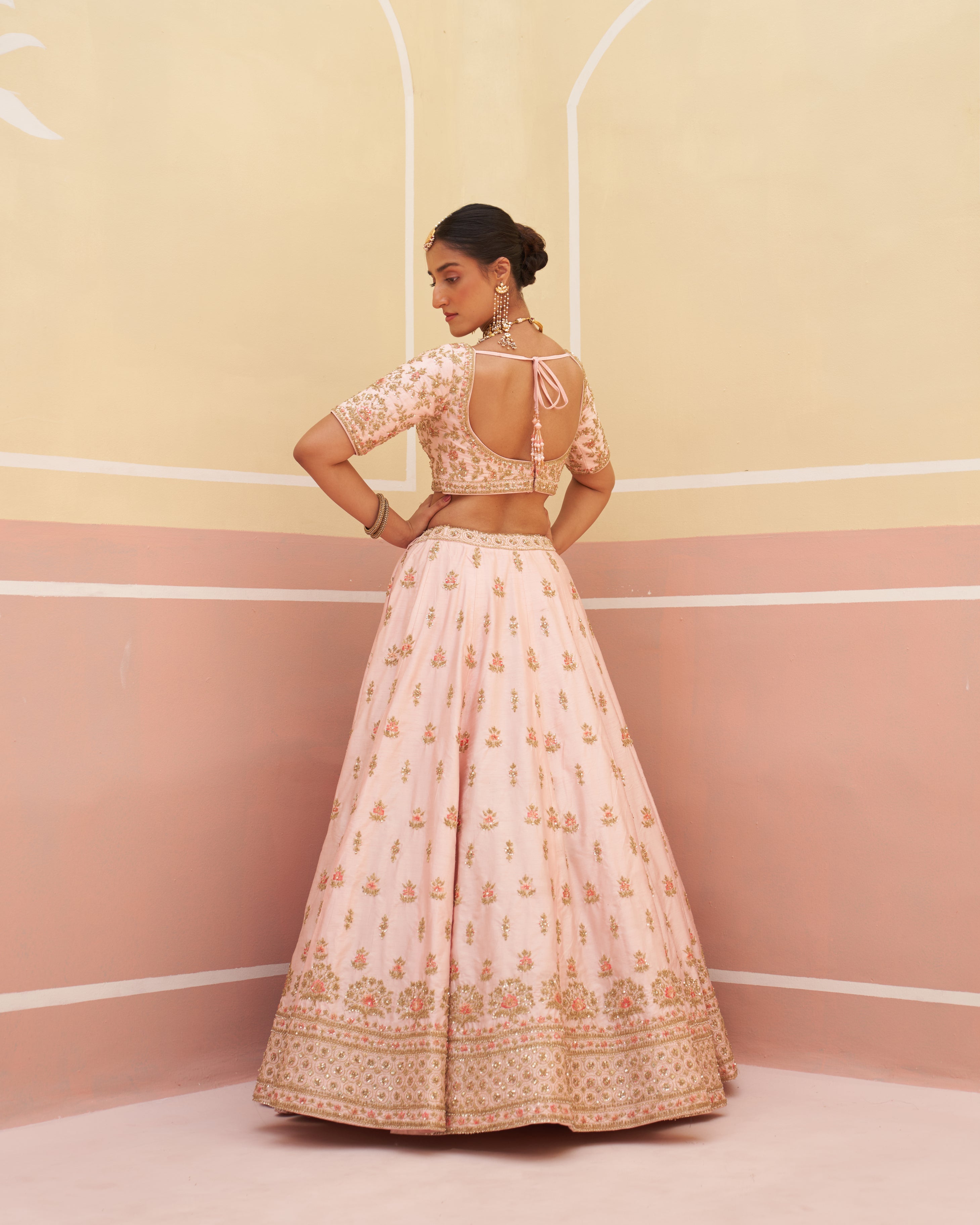 Stunning pink raw silk lehenga set featuring traditional motif