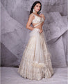 Draped in the timeless elegance of ivory, this bridal lehenga is a vision of pure sophistication.