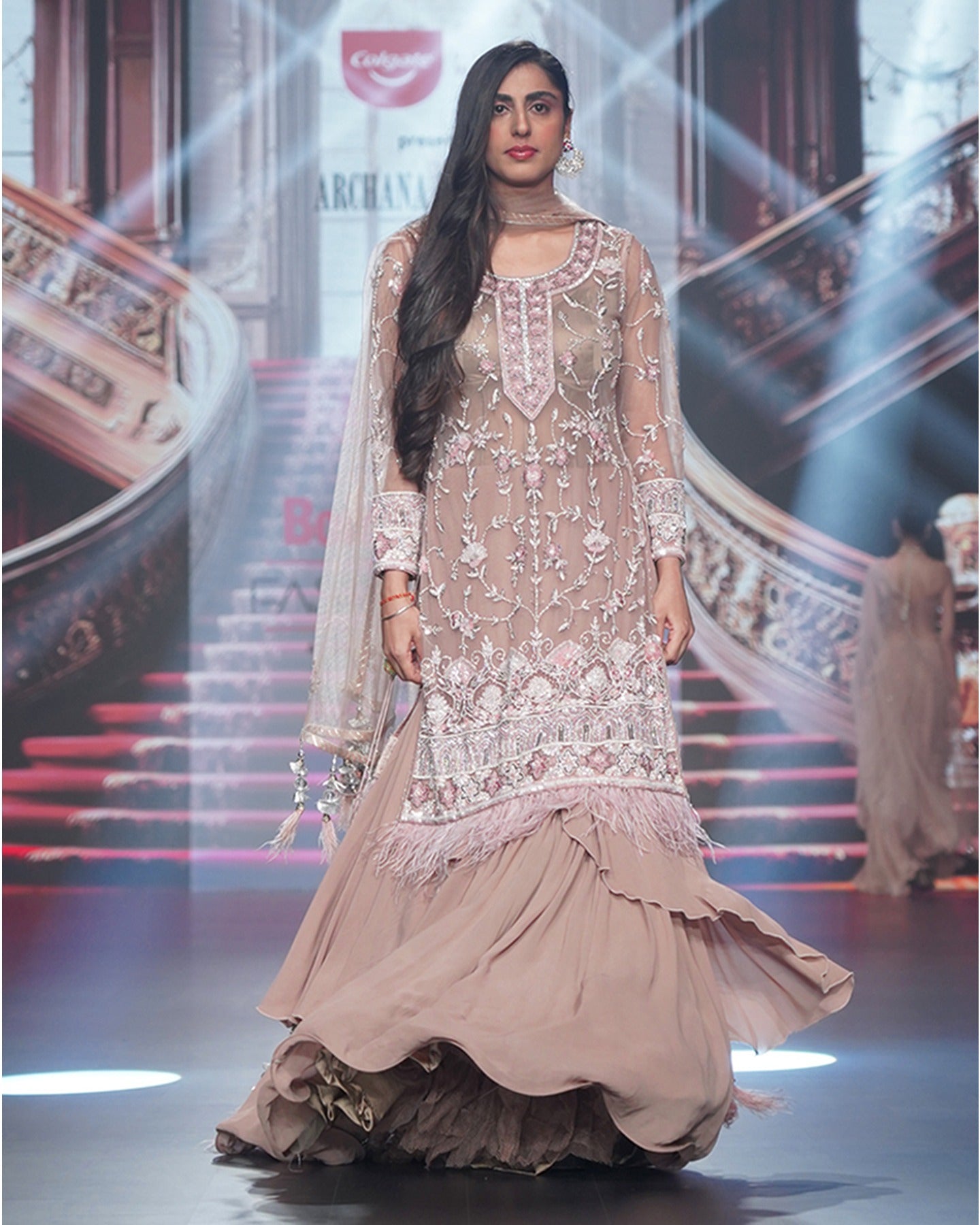 Draped in the rich ecru hue, this anarkali unfolds a story of elegance and intricate floral beauty.