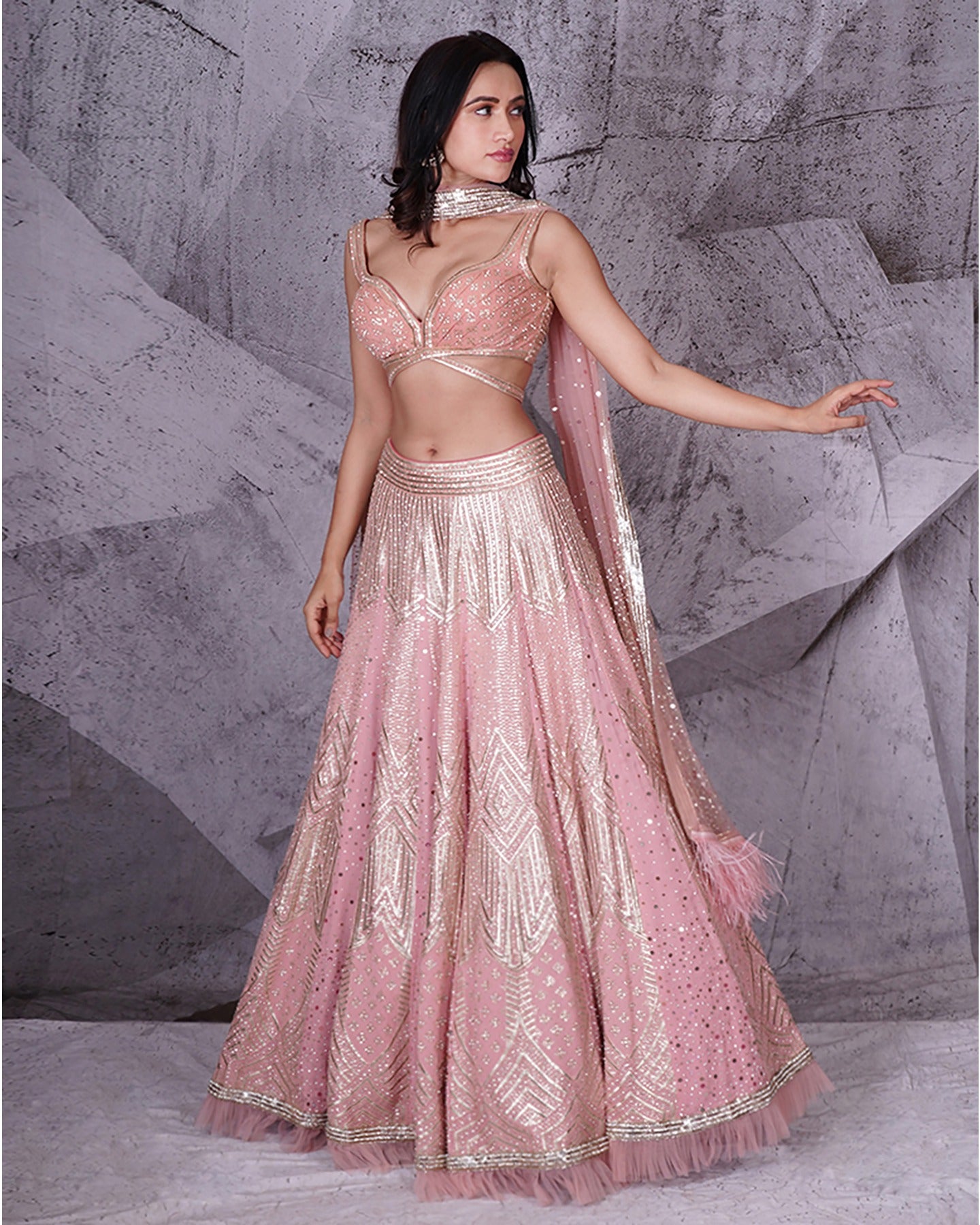Draped in the romantic hues of pink, this bridal lehenga is a symphony of love and grace.