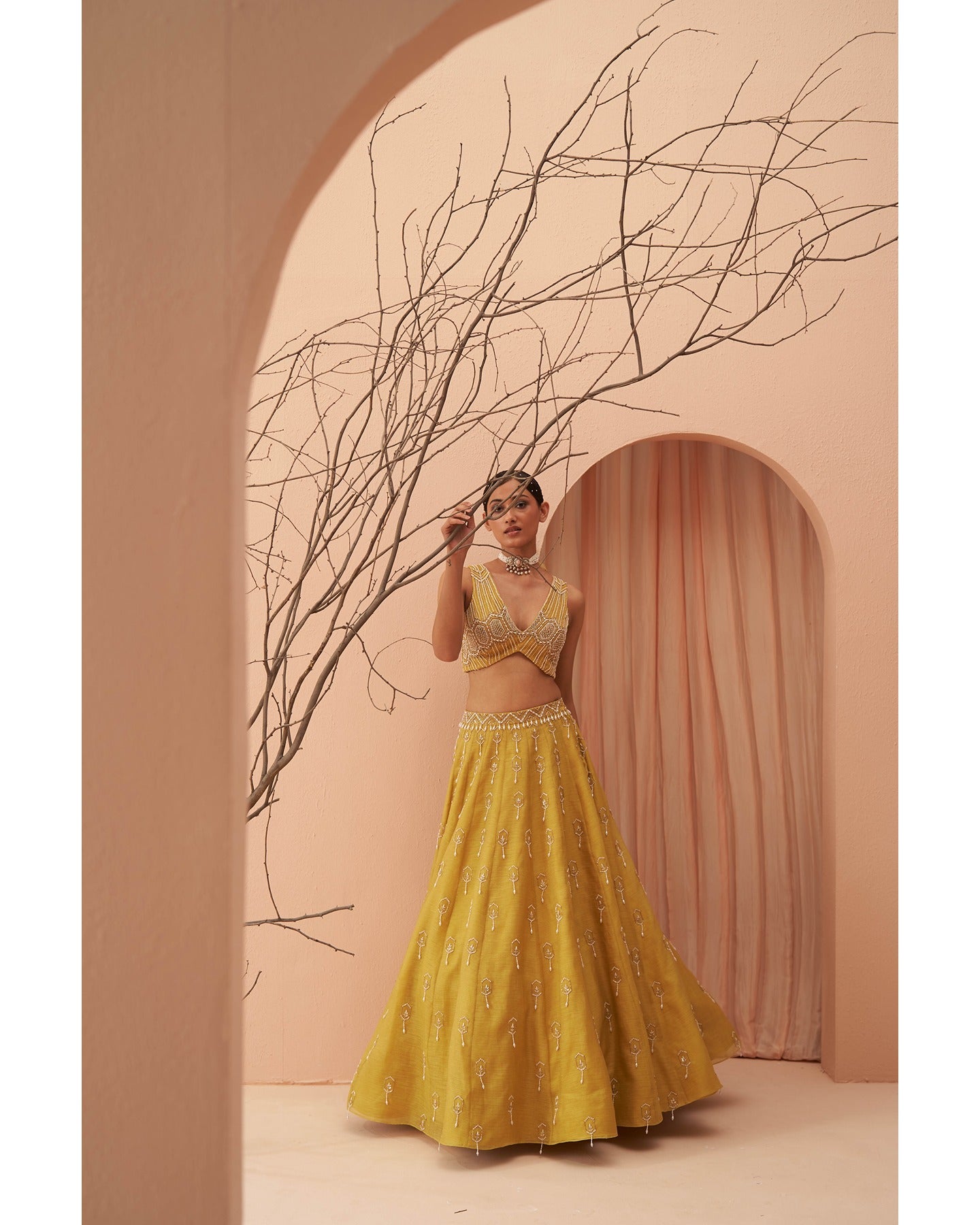 Sunny Splendor: Hand-embroidered grace on a radiant yellow lehenga, a canvas of timeless elegance.