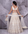 Draped in the timeless elegance of ivory, this bridal lehenga is a vision of pure sophistication.