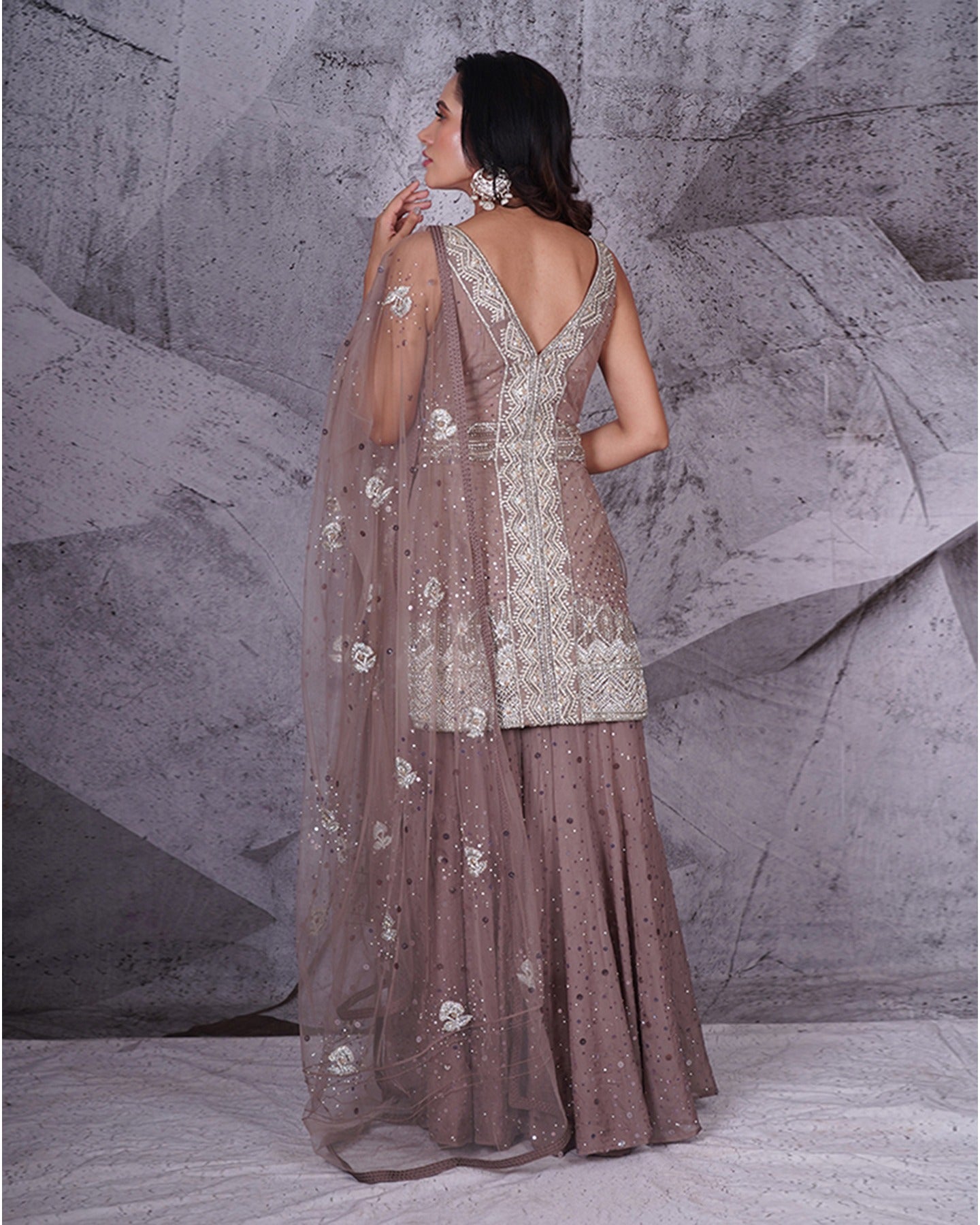 Elegance in every fold: Adorned in a graceful grey sharara set, where traditional charm meets contemporary style.