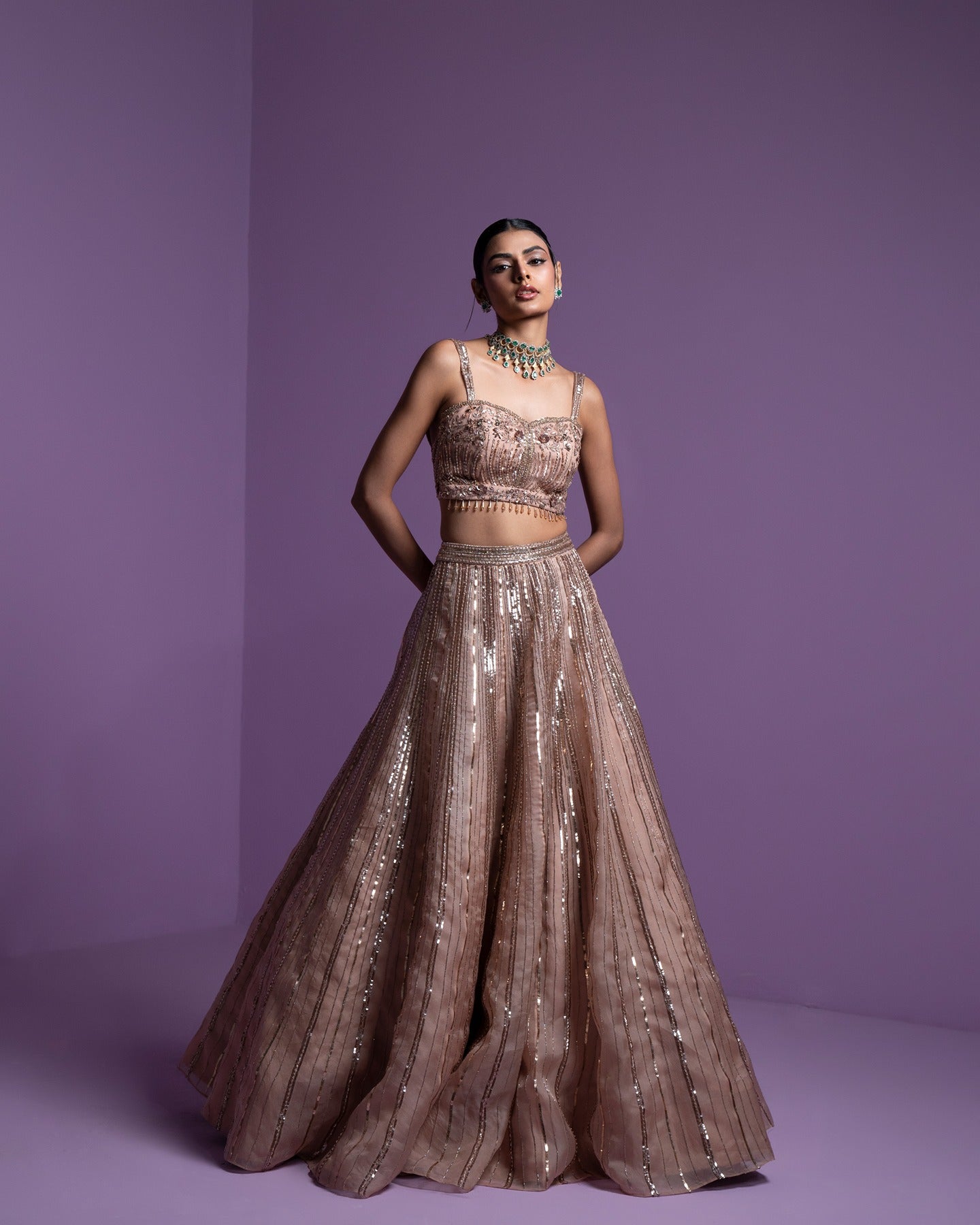 Draped in elegance and adorned in gold, this lehenga radiates timeless beauty and regal charm. A touch of glamour for moments that shimmer with splendor.