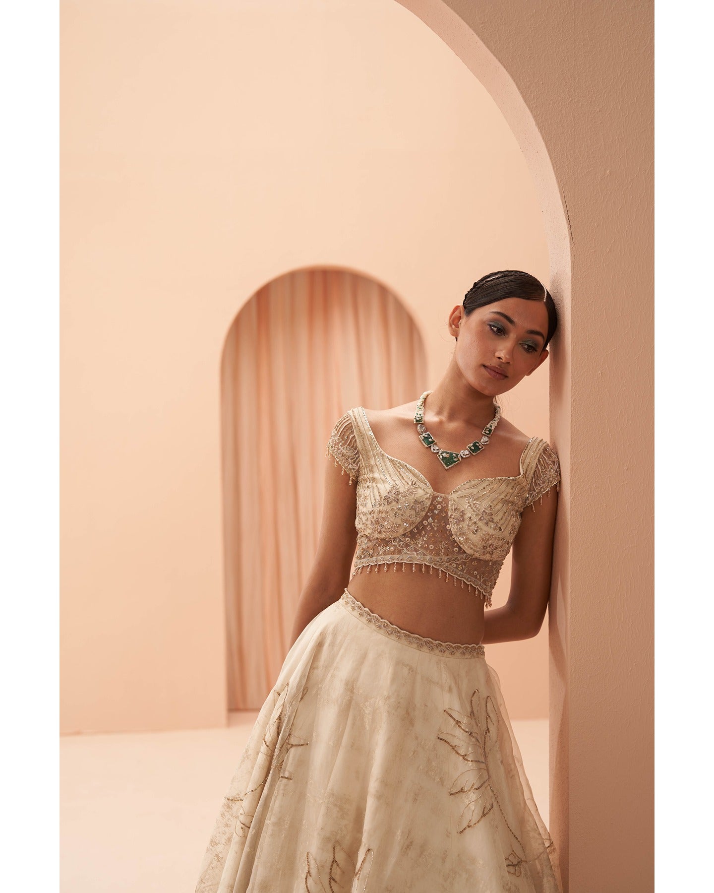 Gilded in Grace: This off-white and gold lehenga is a canvas of hand-embroidered elegance.