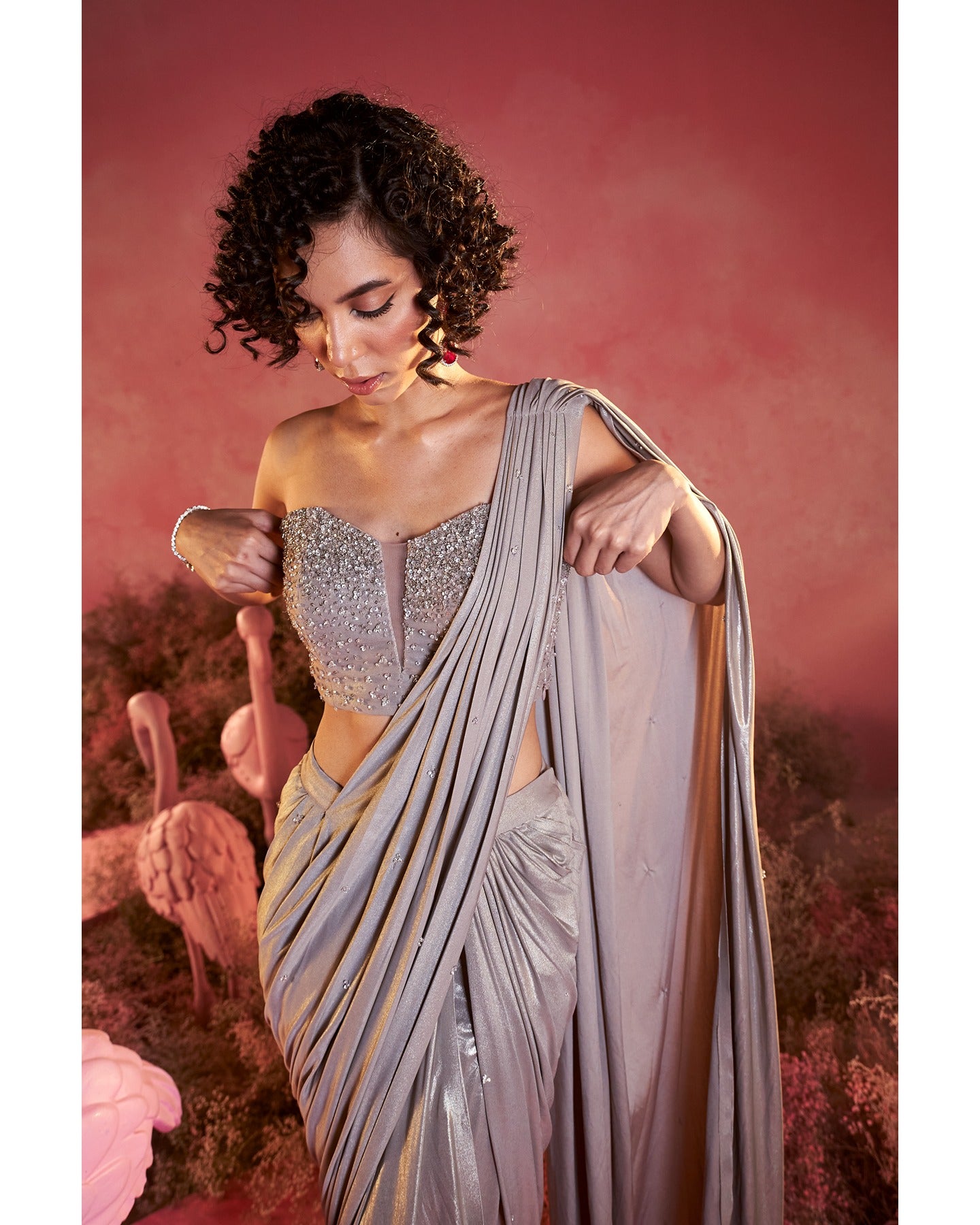 Radiant in Metallics: A mesmerizing saree set adorned with intricate hand-embroidery, where modern glamour meets traditional craftsmanship.