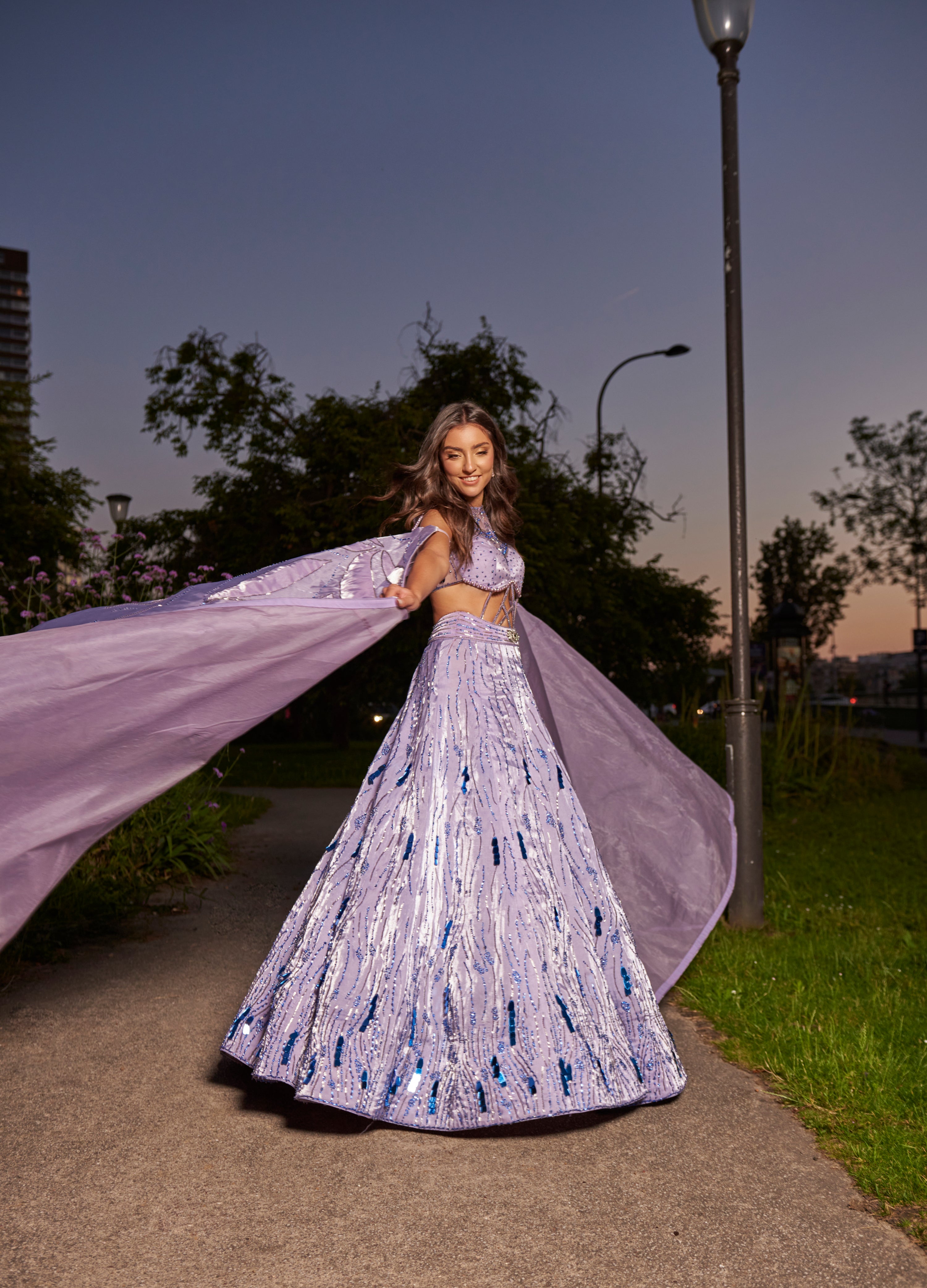 Elegant lavender purple lehenga set, adorned with intricate embroidery on shimmer organza. The matching blouse and dupatta add to the ensemble's ethereal and delicate appeal