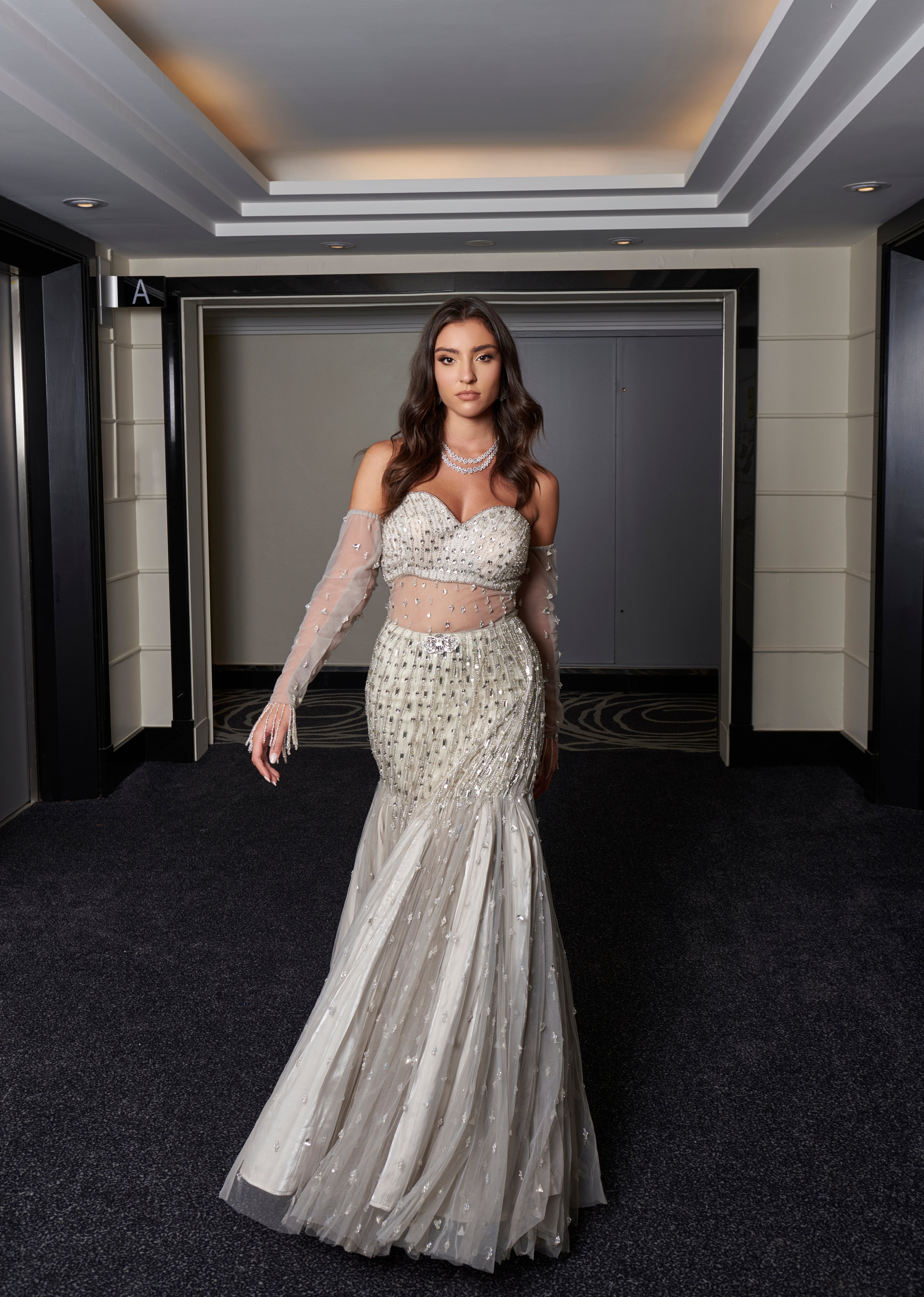 Silver grey fishcut gown adorned with hand crystal work embroidery on net, lined with luxurious habutai silk. This gown exudes sophistication and allure