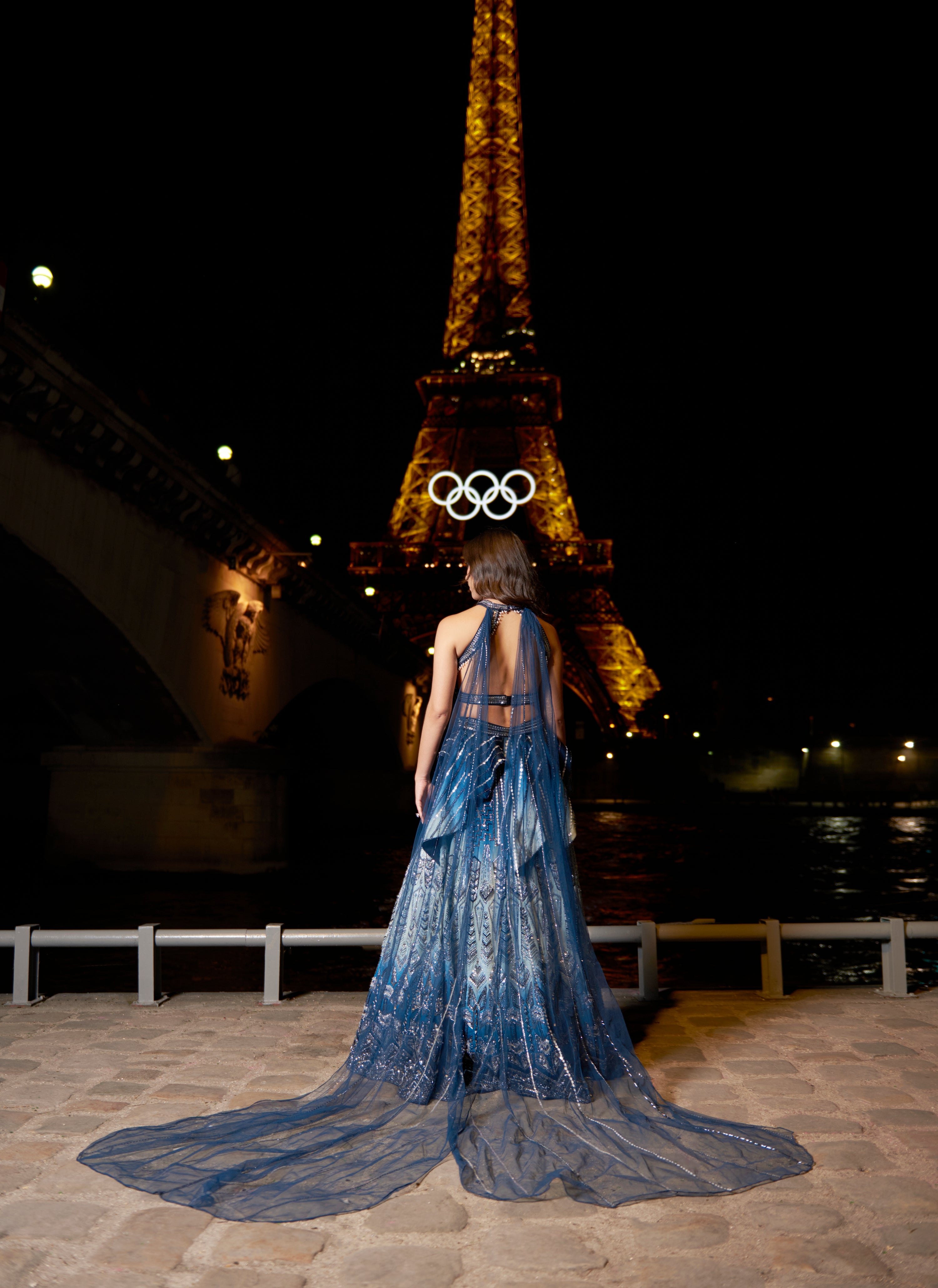 Elegant blue ombre lehenga set, showcasing detailed hand embroidery on linen silk, paired with a halterneck blouse and a detachable net trail