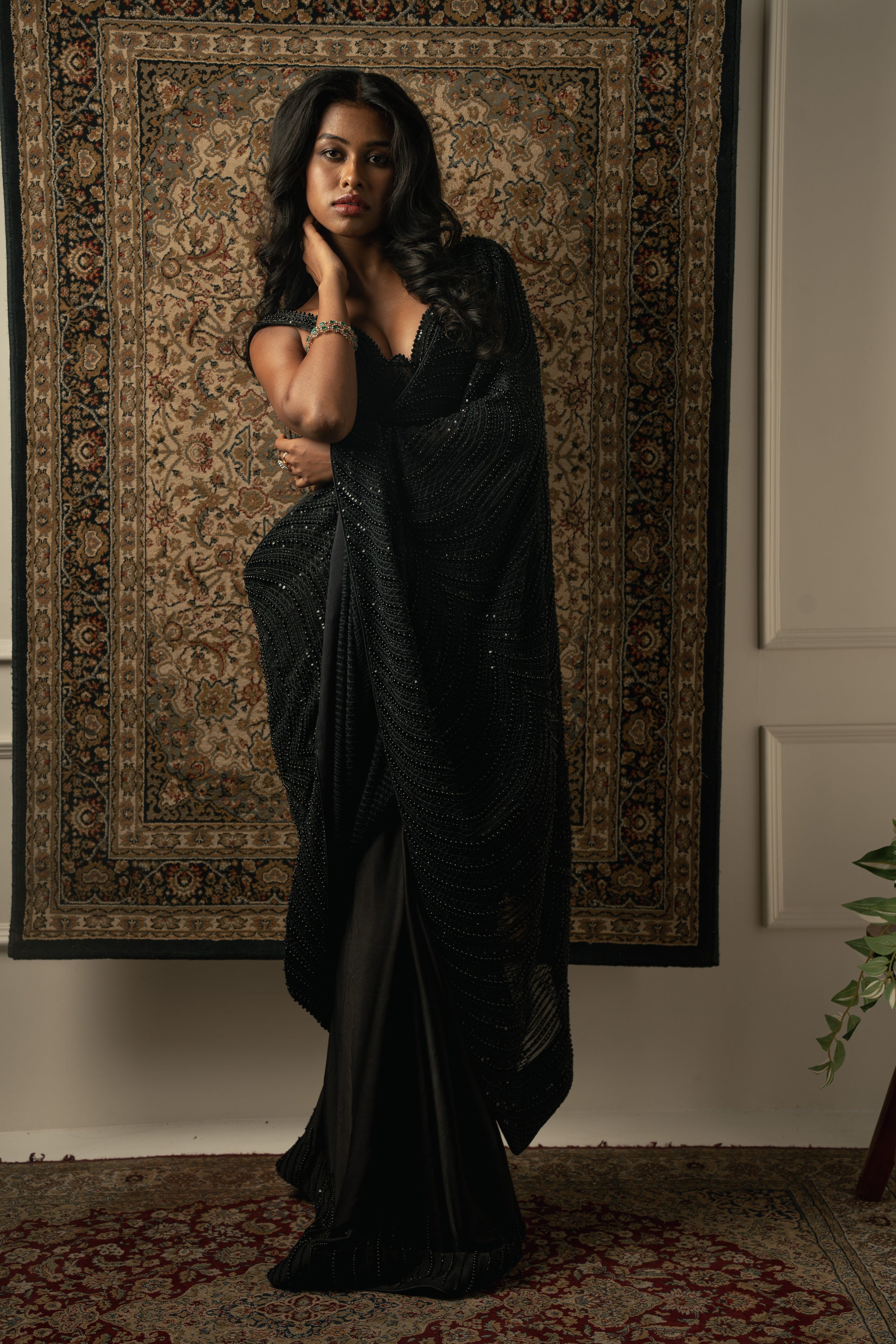 A symphony of textures: Georgette, satin, and shimmer organza come together in this stunning black saree ensemble.