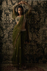 Elevate your ethnic chic with this Olive Green Net Saree and Velvet-Organza blouse ensemble, a fusion of grace and allure.