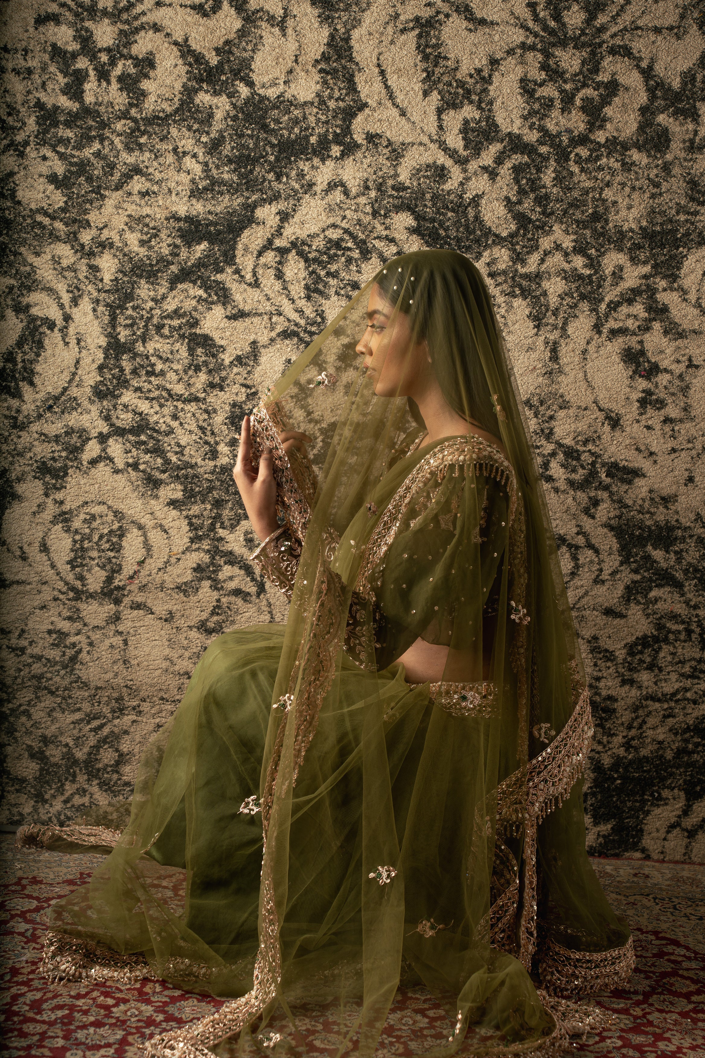 Enchanting in Olive Green: Net Saree paired with a Velvet and Organza blouse, a captivating ensemble that exudes timeless elegance.