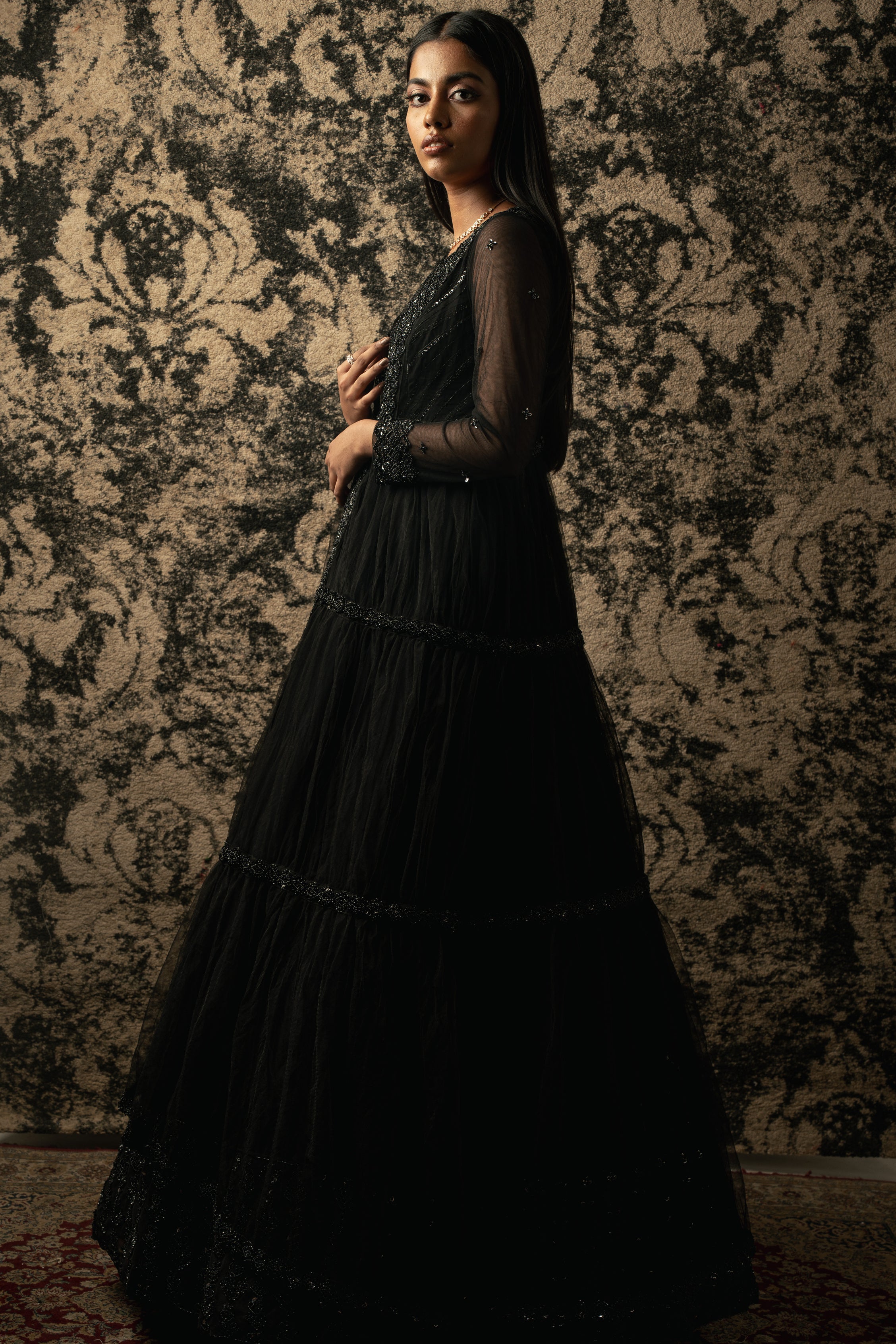 Effortless grace meets sheer elegance: Black organza Anarkali complemented by a delicate net shrug for a stunning ensemble.