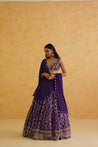 Glamorous purple brocade lehenga with matching dupatta and embroidered blouse.