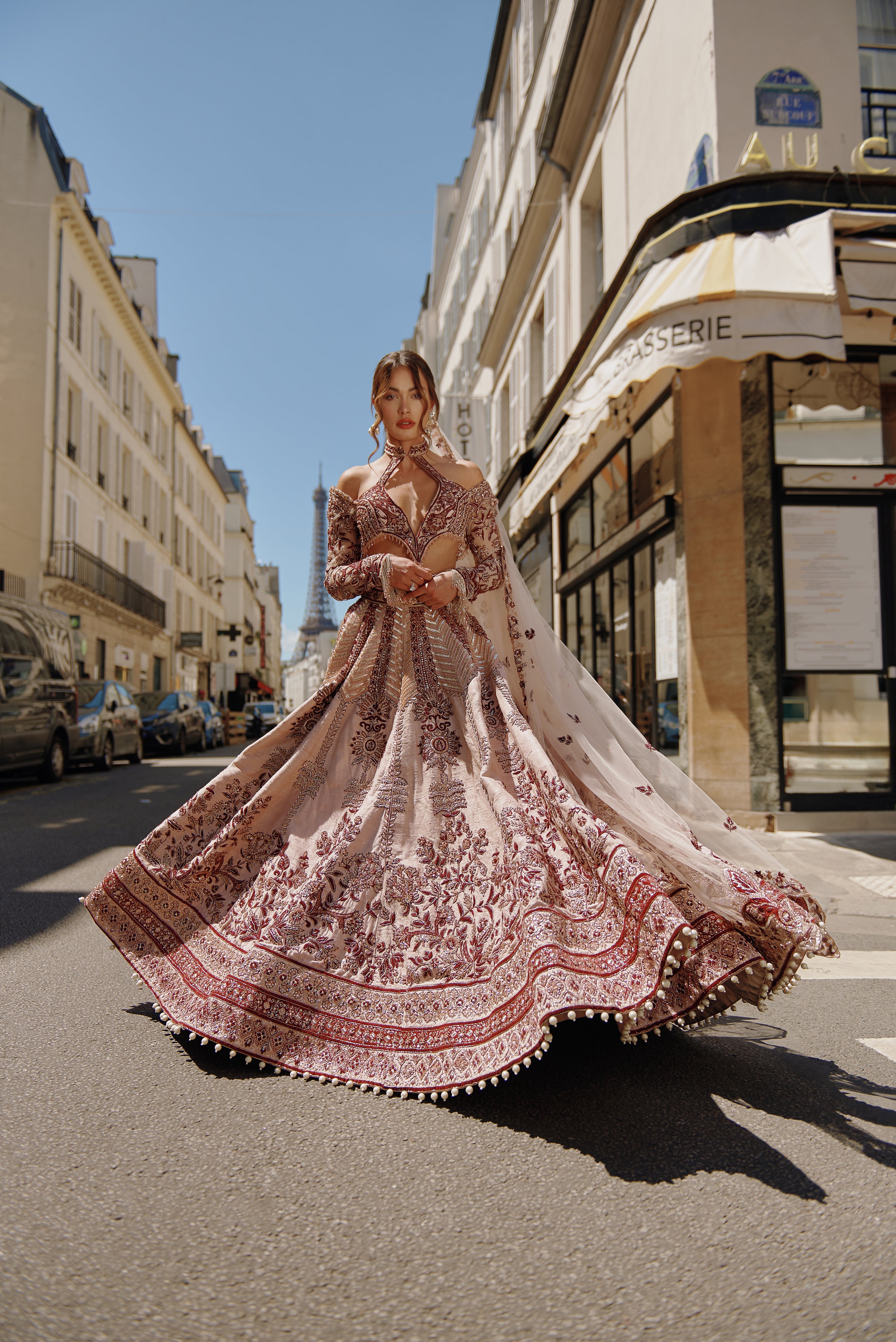 Maroon and ivory lehenga set with handcrafted embroidery on raw silk, featuring a unique silhouette blouse made from net and raw silk. Paired with a delicate net dupatta, this ensemble offers a rich and captivating look