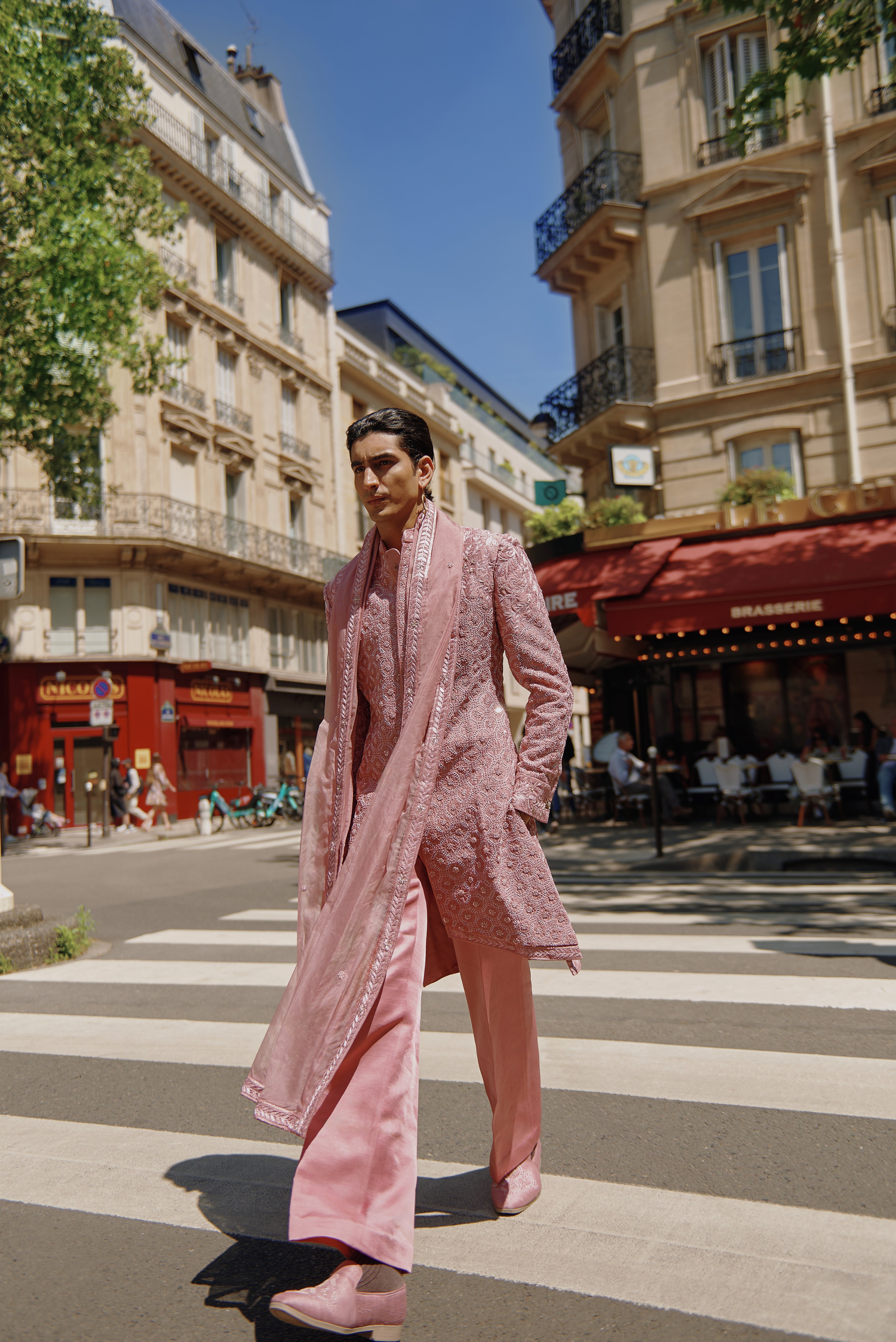 Pink sherwani set with intricate hand crystal work embroidery, crafted from raw silk. Paired with a linen silk kurta and pant, and completed with a delicate organza dupatta, this ensemble exudes regal charm.