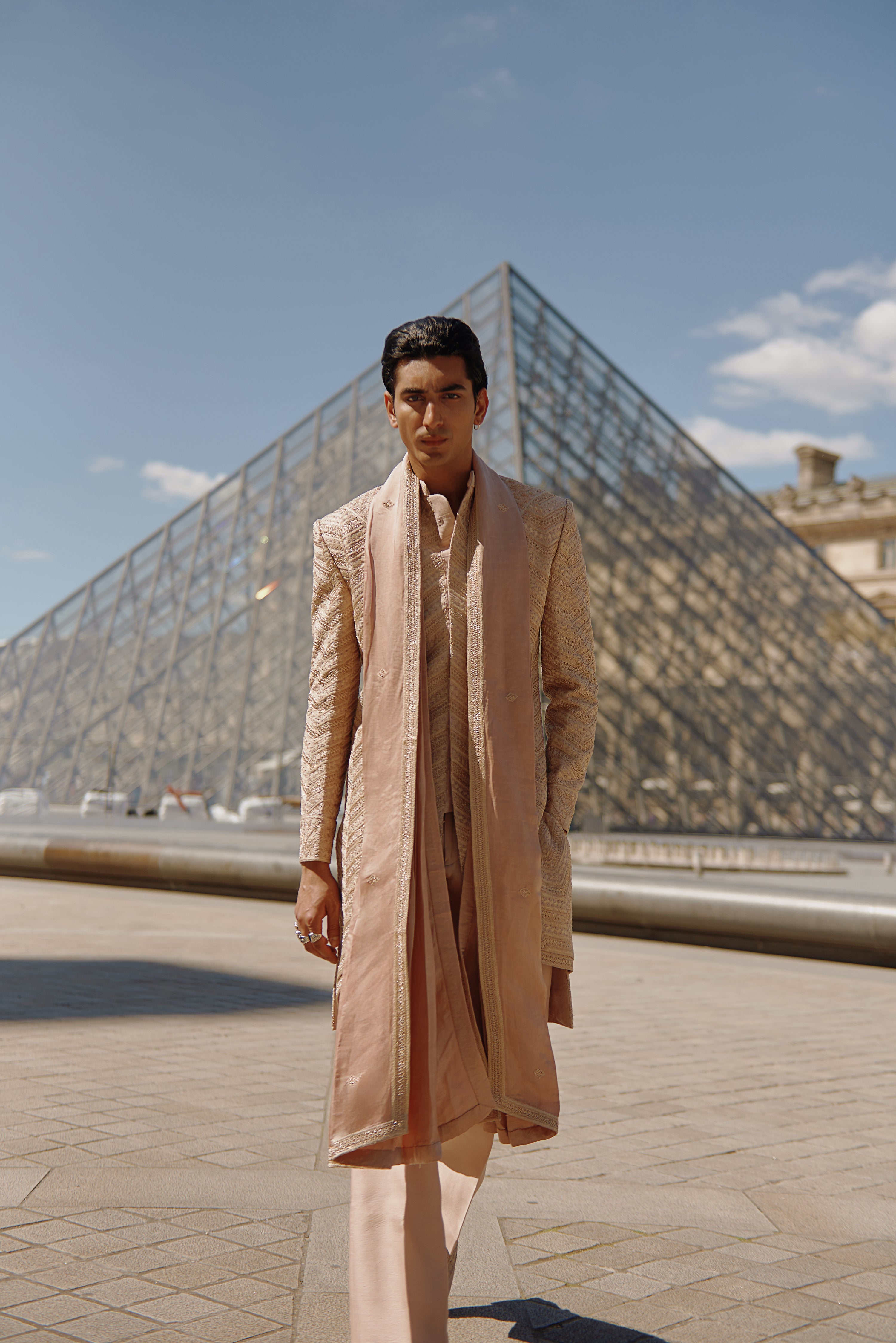 Elegant apricot brown sherwani set, featuring intricate embroidery on raw silk. The Chanderi silk kurta, pant, and a luxurious linen silk dupatta complete the refined look