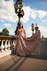 Caramel brown lehenga set with intricate embroidery and pearl embellishments, including pearl danglers. The set features a linen silk lehenga and a net and linen silk blouse with a sea shell-inspired design, completed by a delicate net dupatta