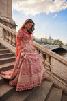 Carnelian red lehenga set with full sleeves, adorned with detailed hand embroidery and pearls, made from rich raw silk and velvet, complemented by a net blouse and dupatta for a sheer, elegant finish.