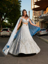 Ice blue lehenga set with intricate hand embroidery, featuring an organza lehenga and blouse. The ensemble is completed with a unique trail organza dupatta, exuding contemporary elegance.