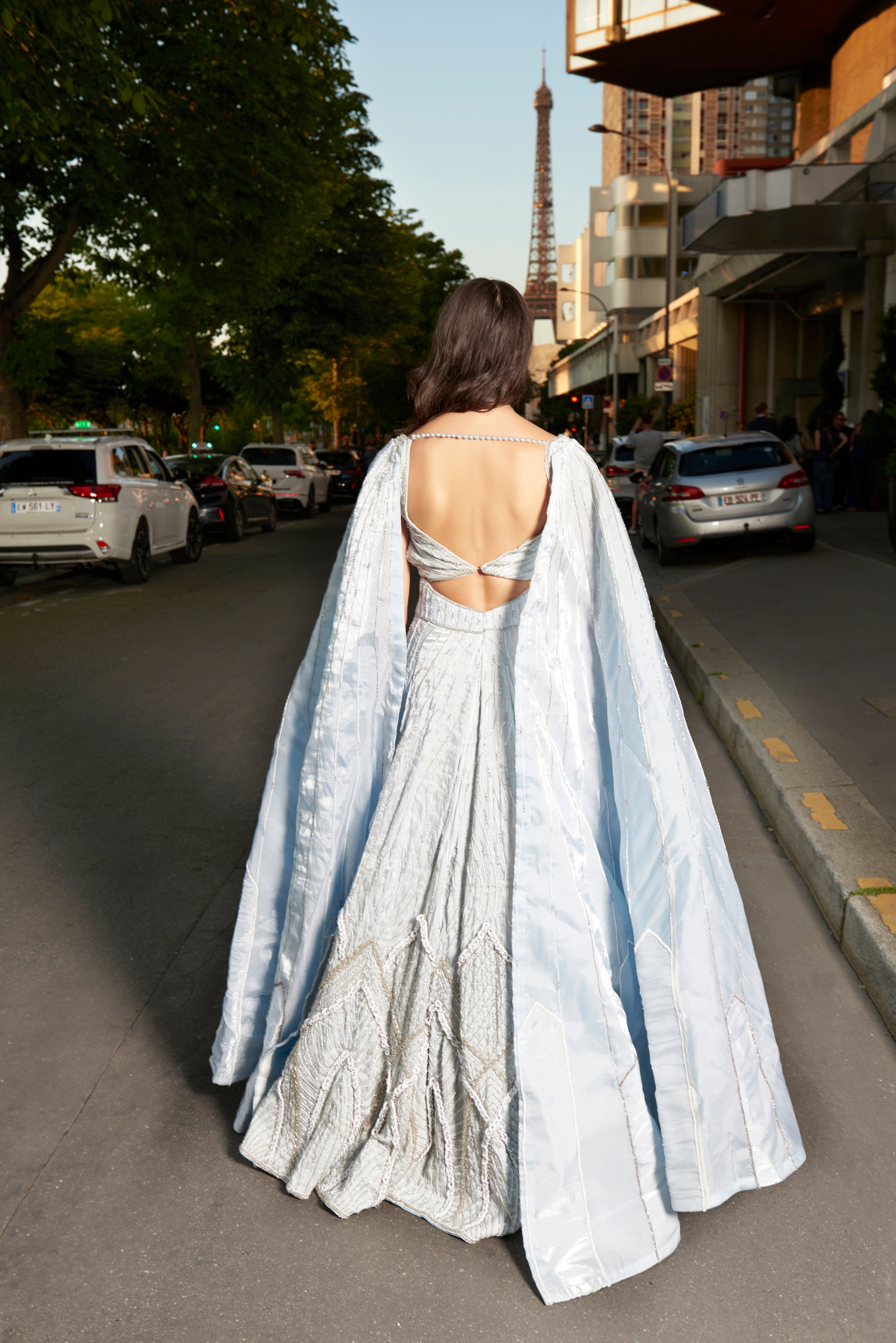 Ice blue organza lehenga set, adorned with exquisite hand embroidery. Paired with a trail dupatta, this ensemble blends contemporary style with timeless sophistication.