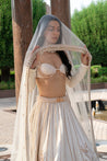 Pearl white lehenga with delicate Chikankari embroidery, a shell-inspired blouse with pearl details, and an ethereal net dupatta