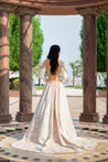 Pearl white linen satin lehenga with intricate Chikankari work, full-sleeved blouse adorned with pearls, and a light net dupatta