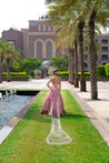 Luxurious salmon pink velvet lehenga set featuring a V-neck sleeveless blouse and a graceful net dupatta