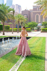 Luxurious salmon pink velvet lehenga set featuring a V-neck sleeveless blouse and a graceful net dupatta