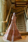 Opulent raw silk and velvet lehenga in ochre rust, paired with a silk-net blouse and a dupatta showcasing intricate resham, poth, and zari work