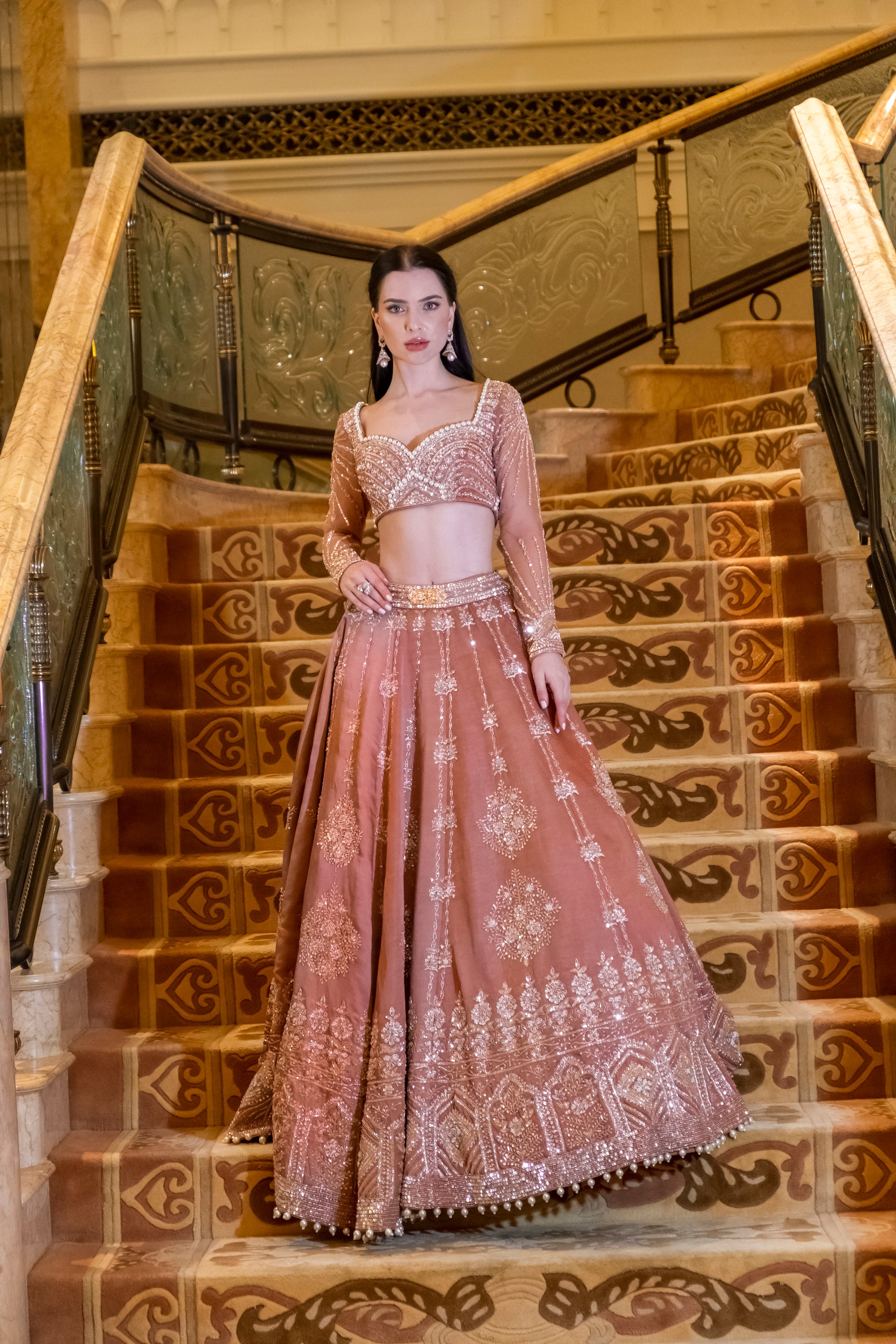 Peru brown Habutai silk lehenga with intricate handwork, paired with a matching blouse featuring net sleeves and a graceful net dupatta