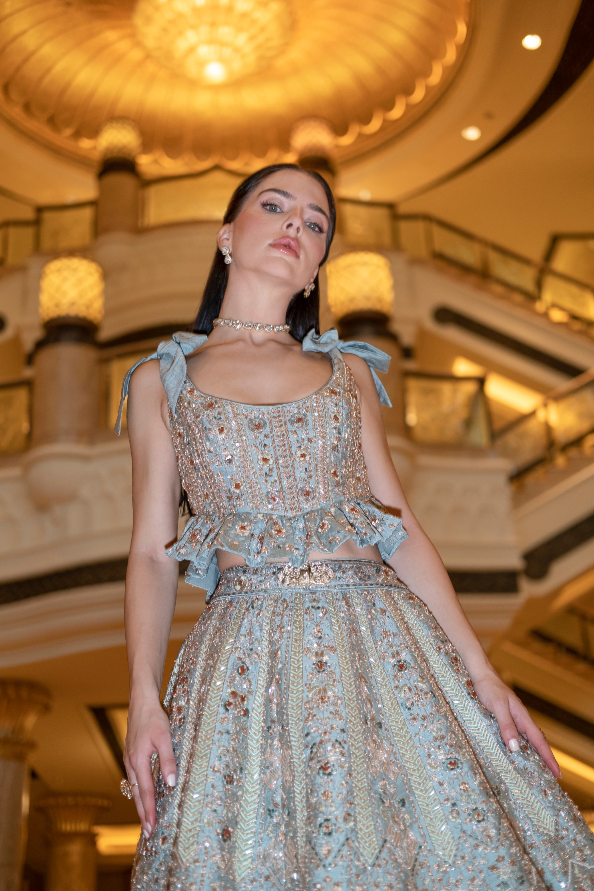 Minty sage green lehenga with teal drop appliqué, a raw silk peplum blouse, and an elegant net dupatta.