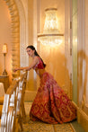 Opulent raw silk lehenga in cerise pink with velvet patchwork, complemented by a pearl-adorned blouse and ethereal net dupatta