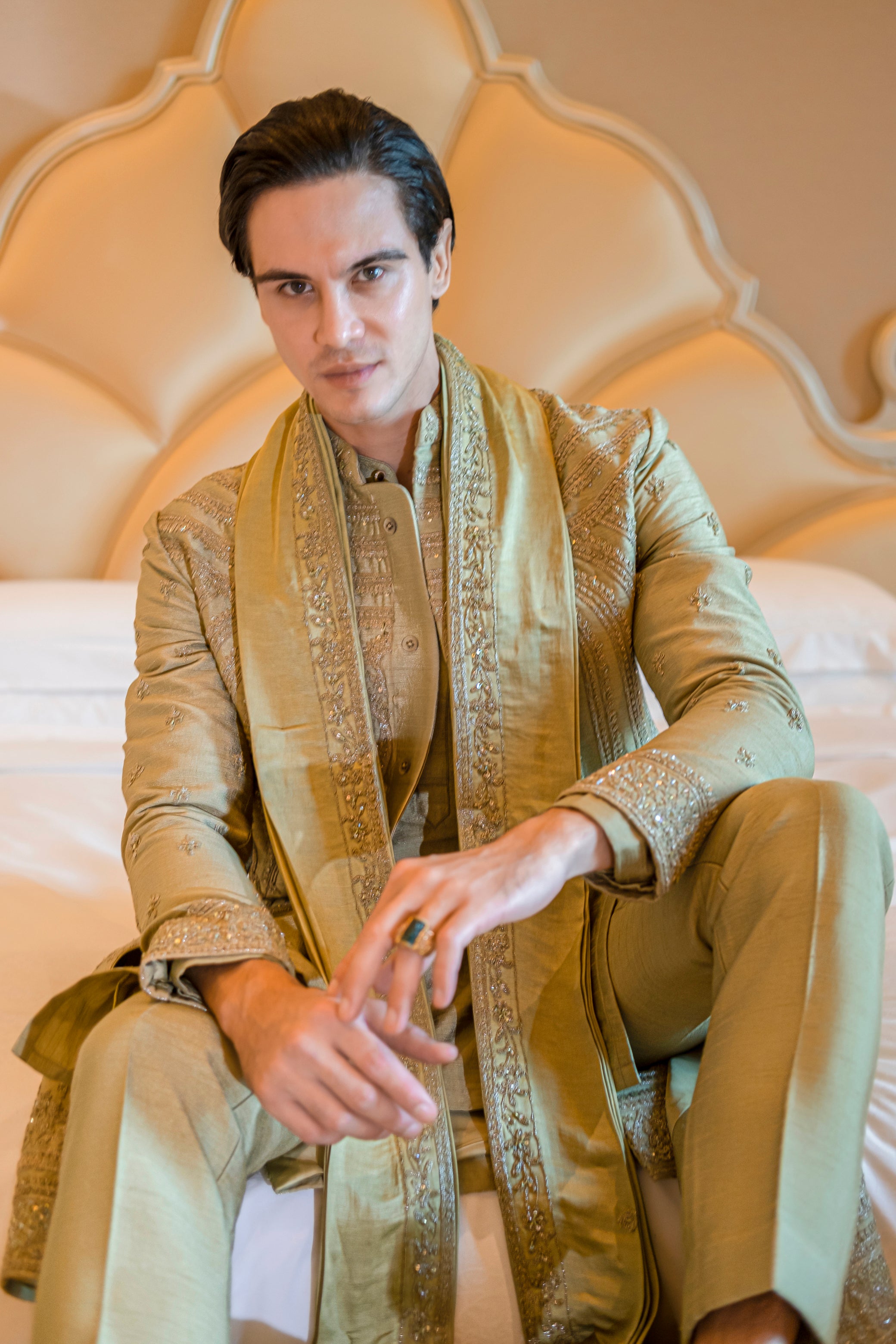 Rich cardamom green sherwani with intricate hand-embroidery, cut dana, and sequin accents, completed with a linen satin dupatta.