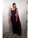 Draped in the regal richness of aubergine, this saree weaves a tale of timeless elegance. 