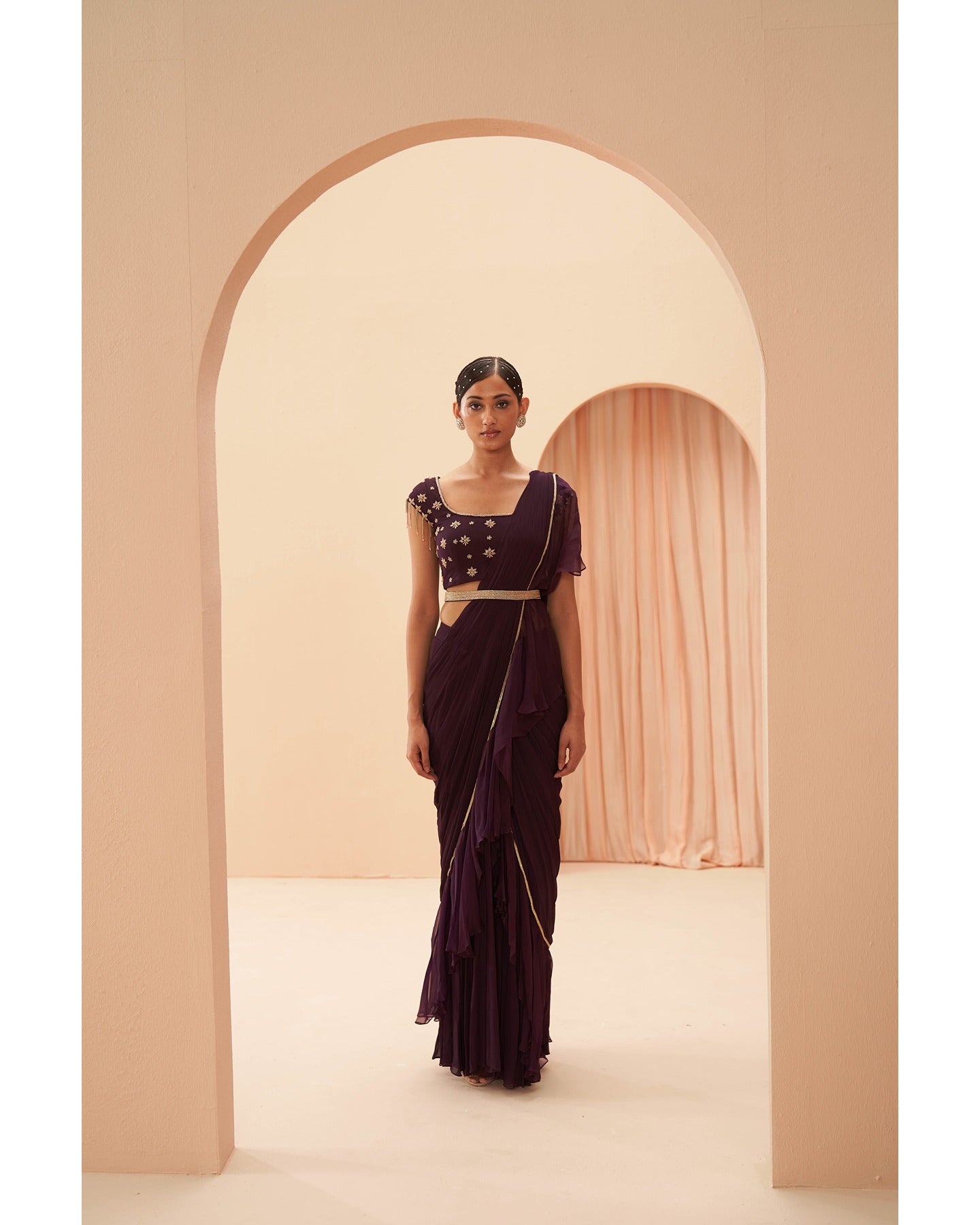 Wine Elegance Unveiled: Hand-embroidered details grace this deep wine drape saree, a symphony of sophistication and allure.