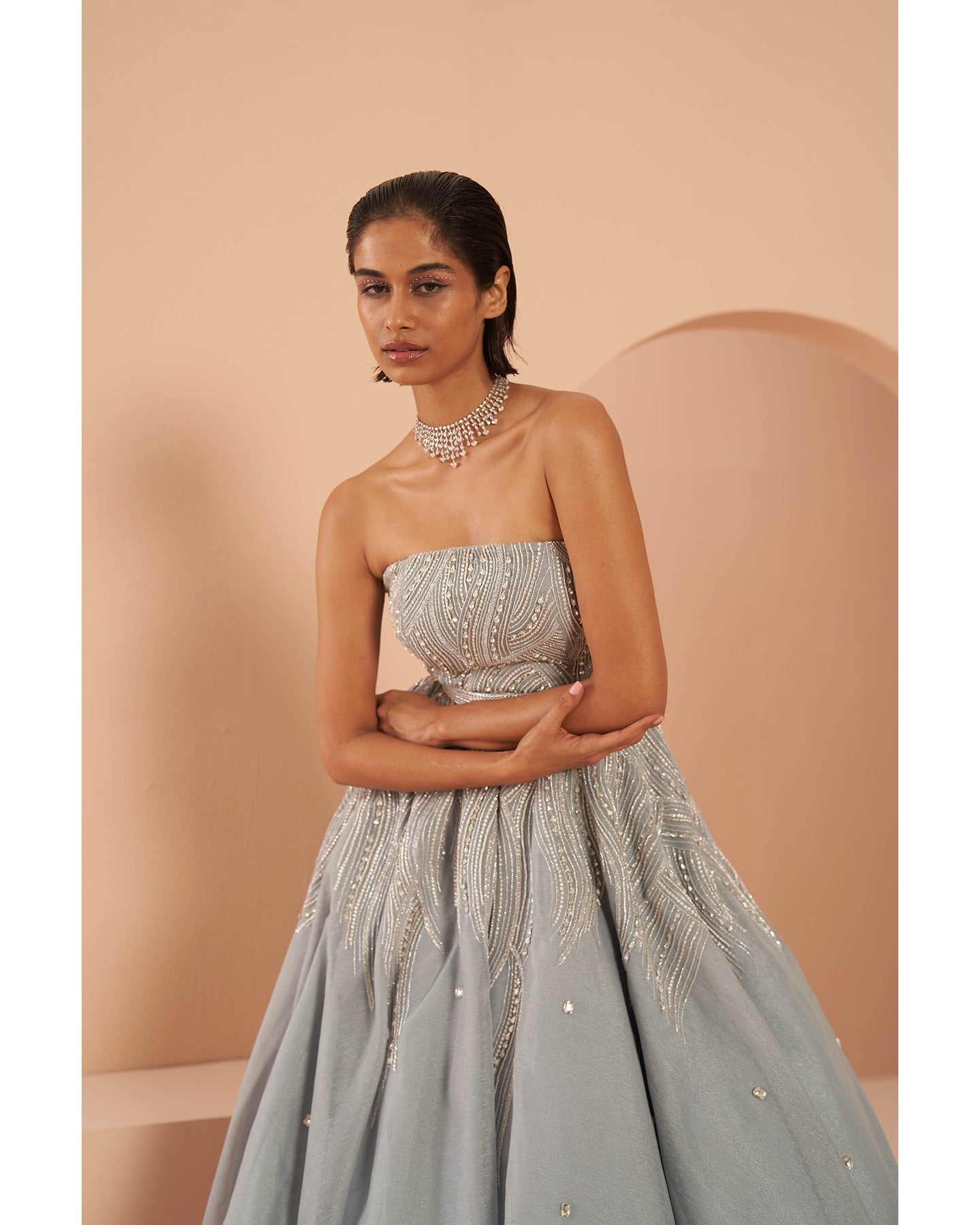 Ice Queen Elegance: Hand-embroidered perfection graces this strapless ice blue gown, a captivating blend of sophistication and charm.