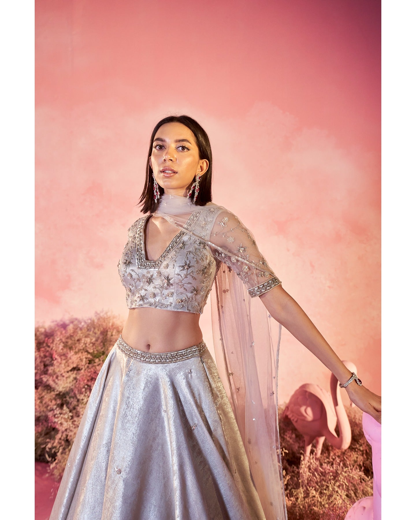 Bridal lehenga adorned with hand-embroidered geometric patterns and sequin embellishments.