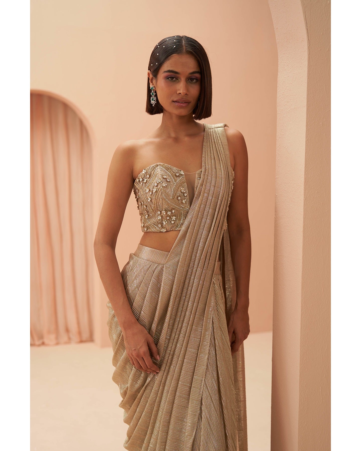Gilded Grace: Hand-embroidered enchantment graces this golden drape saree, a radiant masterpiece of timeless elegance.